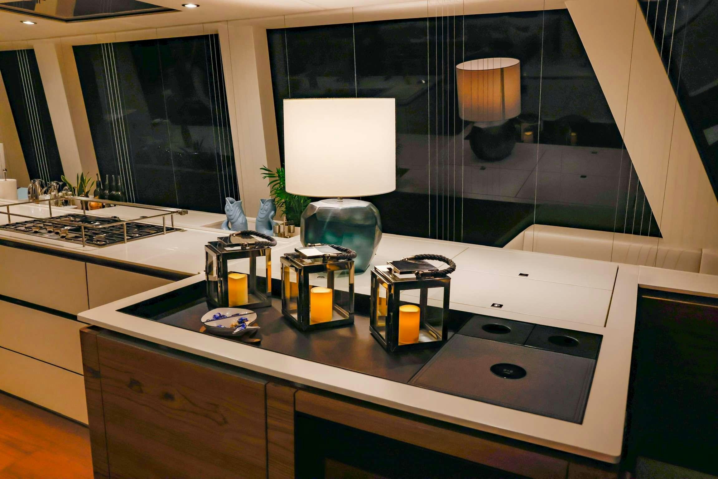 a kitchen with a large mirror aboard SUNREEF 80 FANTASTIC TOO Yacht for Charter