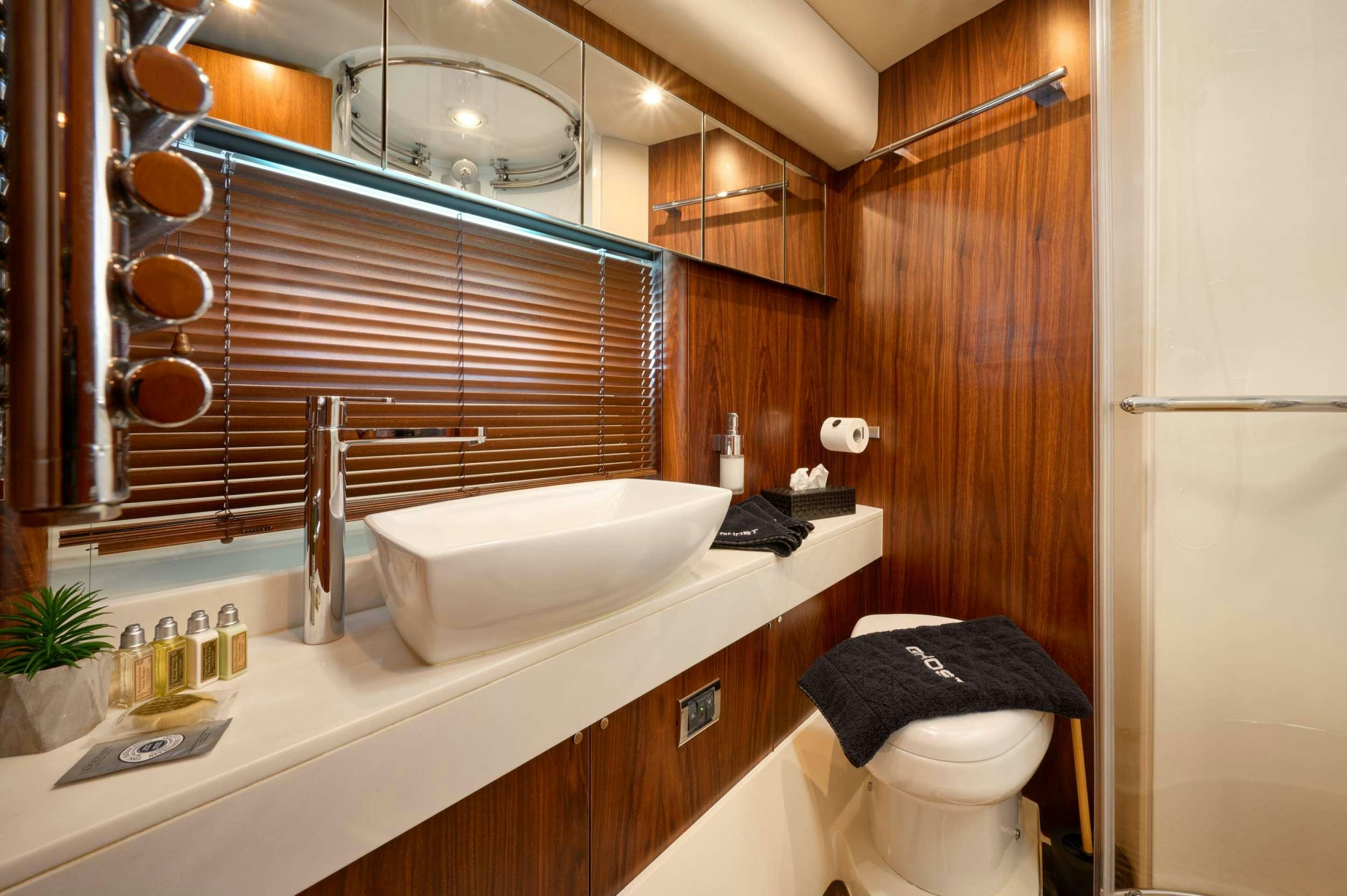 a bathroom with a sink and a toilet aboard SUNSEEKER PREDATOR 72 GHOST Yacht for Charter