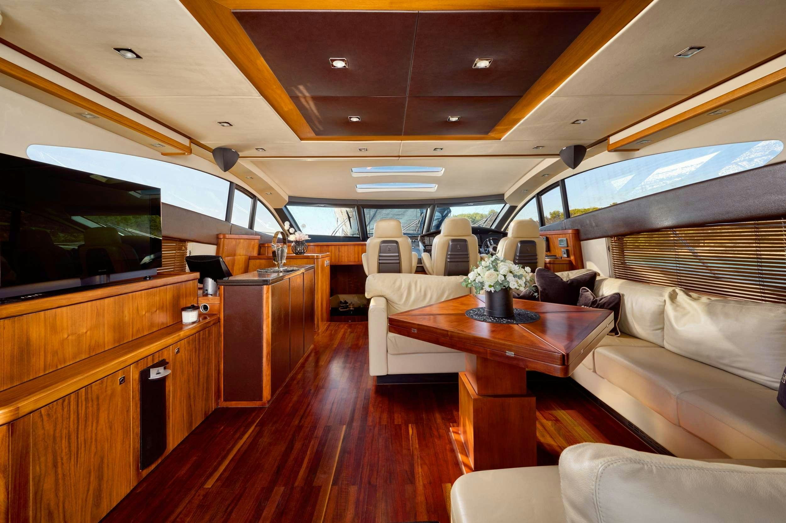 a living room with a wood floor aboard SUNSEEKER PREDATOR 72 GHOST Yacht for Charter