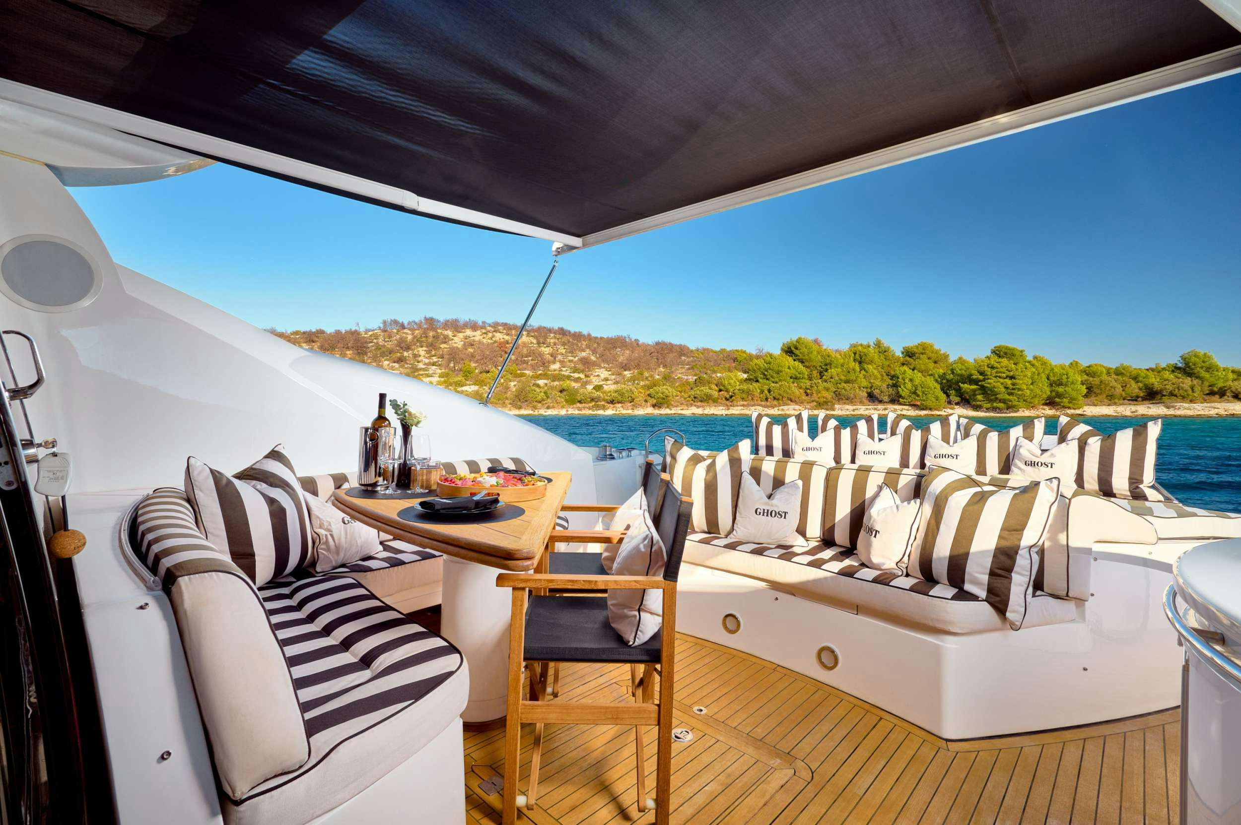 a table and chairs on a deck aboard SUNSEEKER PREDATOR 72 GHOST Yacht for Charter