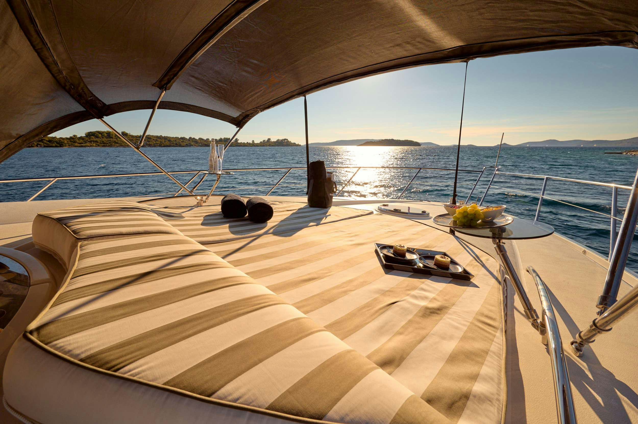 a large white bed on a boat aboard SUNSEEKER PREDATOR 72 GHOST Yacht for Charter
