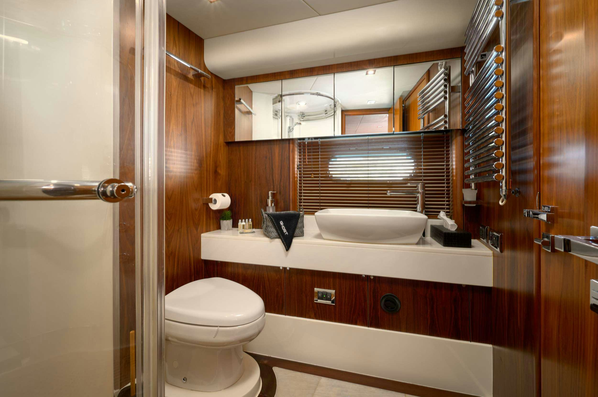 a bathroom with a toilet and a sink aboard SUNSEEKER PREDATOR 72 GHOST Yacht for Charter