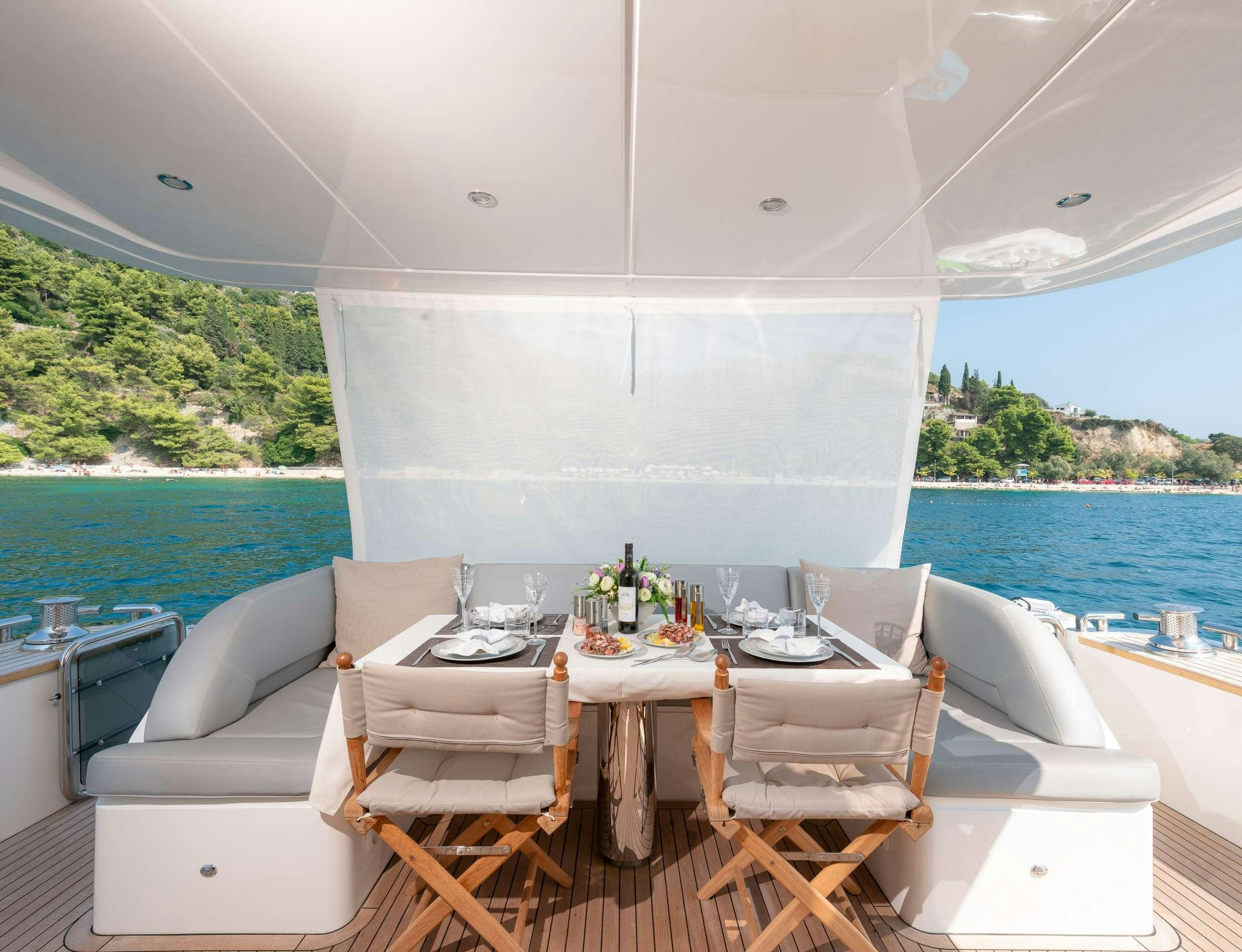 a table set for a meal on a boat aboard PRINCESS 72 FLY CHAMPION Yacht for Charter