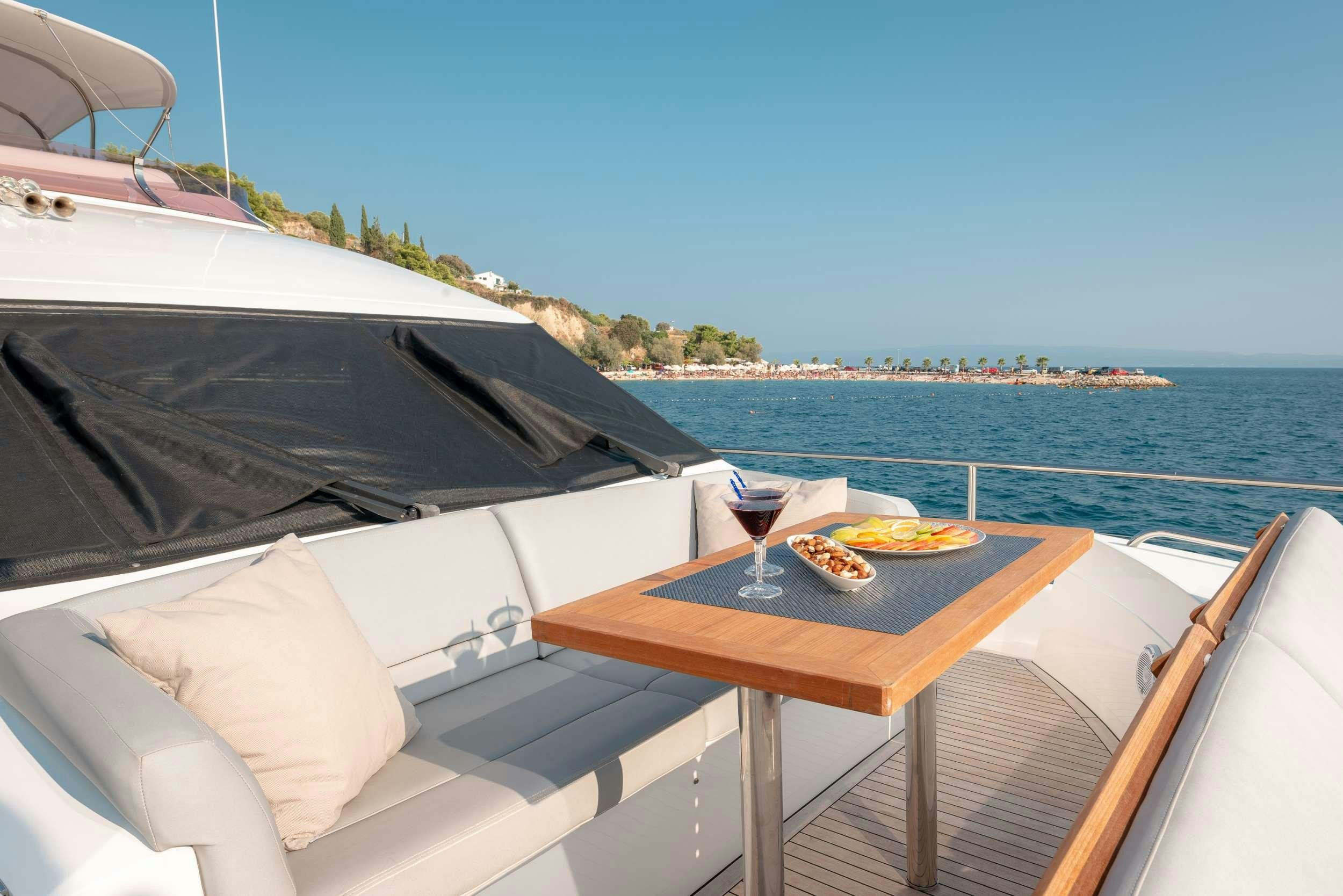 a table with food on it by the water aboard PRINCESS 72 FLY CHAMPION Yacht for Charter