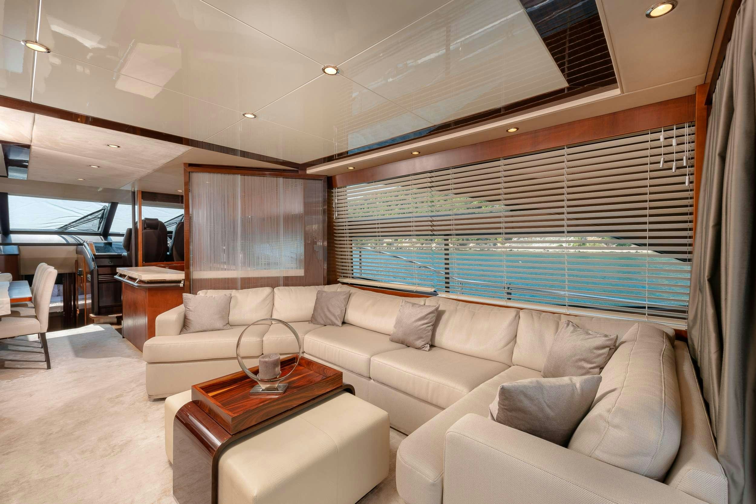 a living room with a couch and a pool table aboard PRINCESS 72 FLY CHAMPION Yacht for Charter
