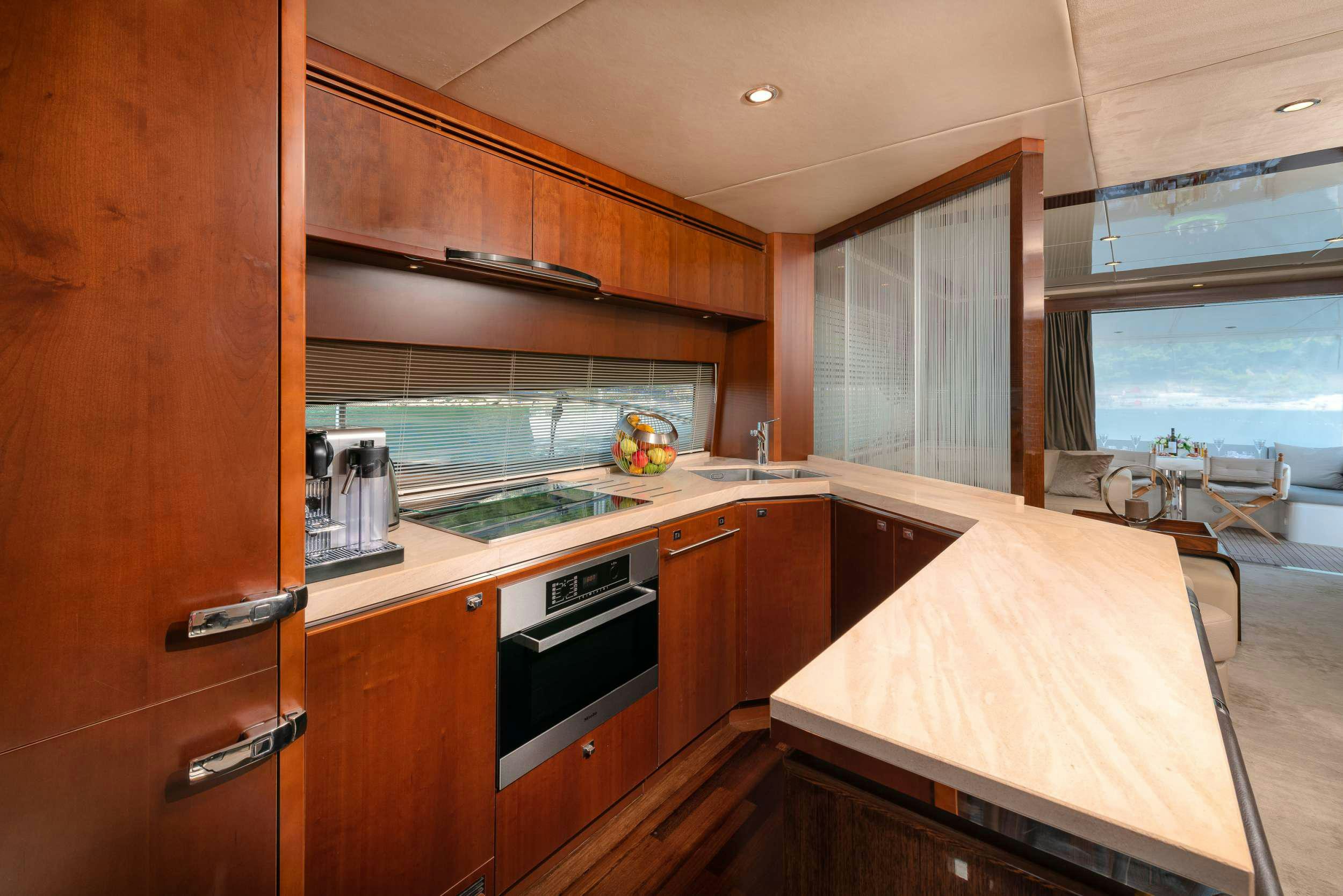 a kitchen with wooden cabinets aboard PRINCESS 72 FLY CHAMPION Yacht for Charter