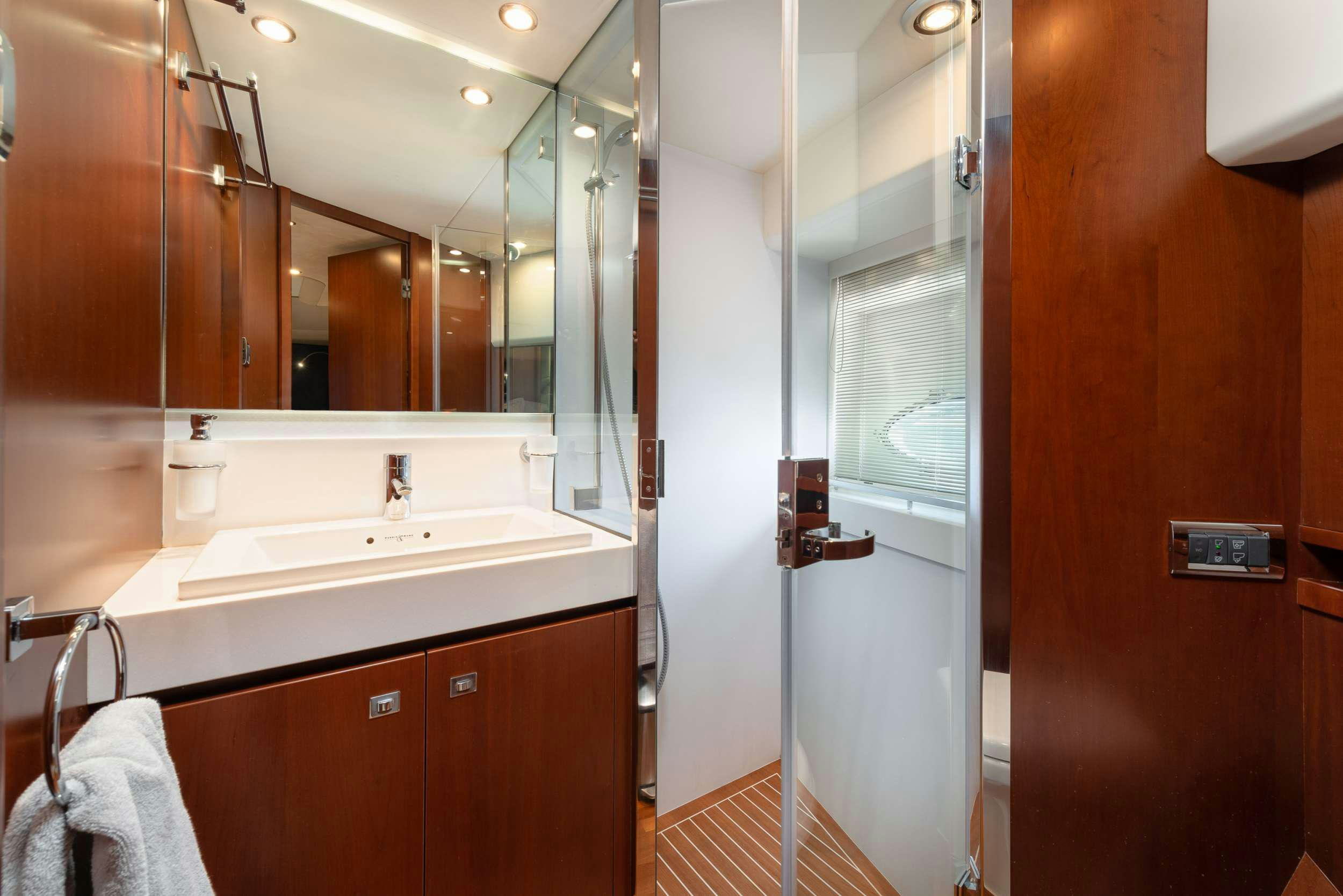 a bathroom with a sink and a mirror aboard PRINCESS 72 FLY CHAMPION Yacht for Charter