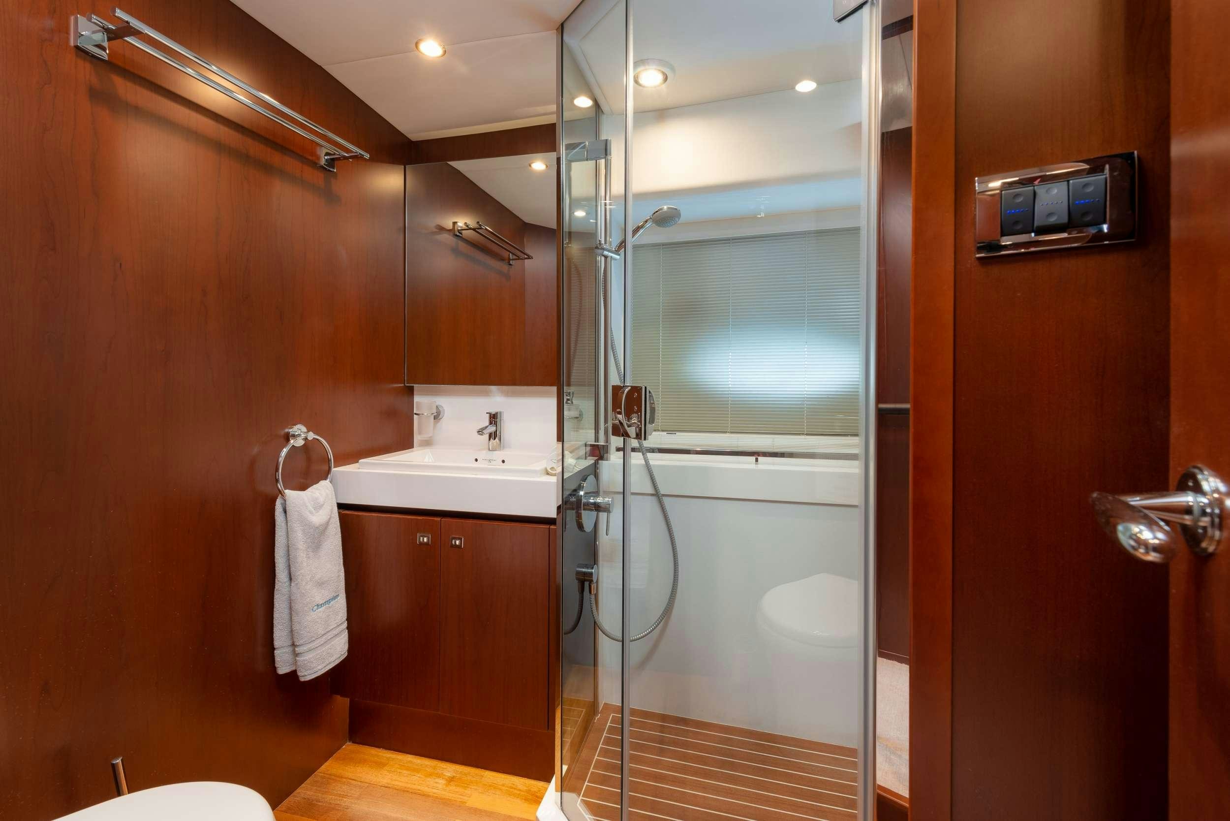 a bathroom with a shower unit and sink aboard PRINCESS 72 FLY CHAMPION Yacht for Charter