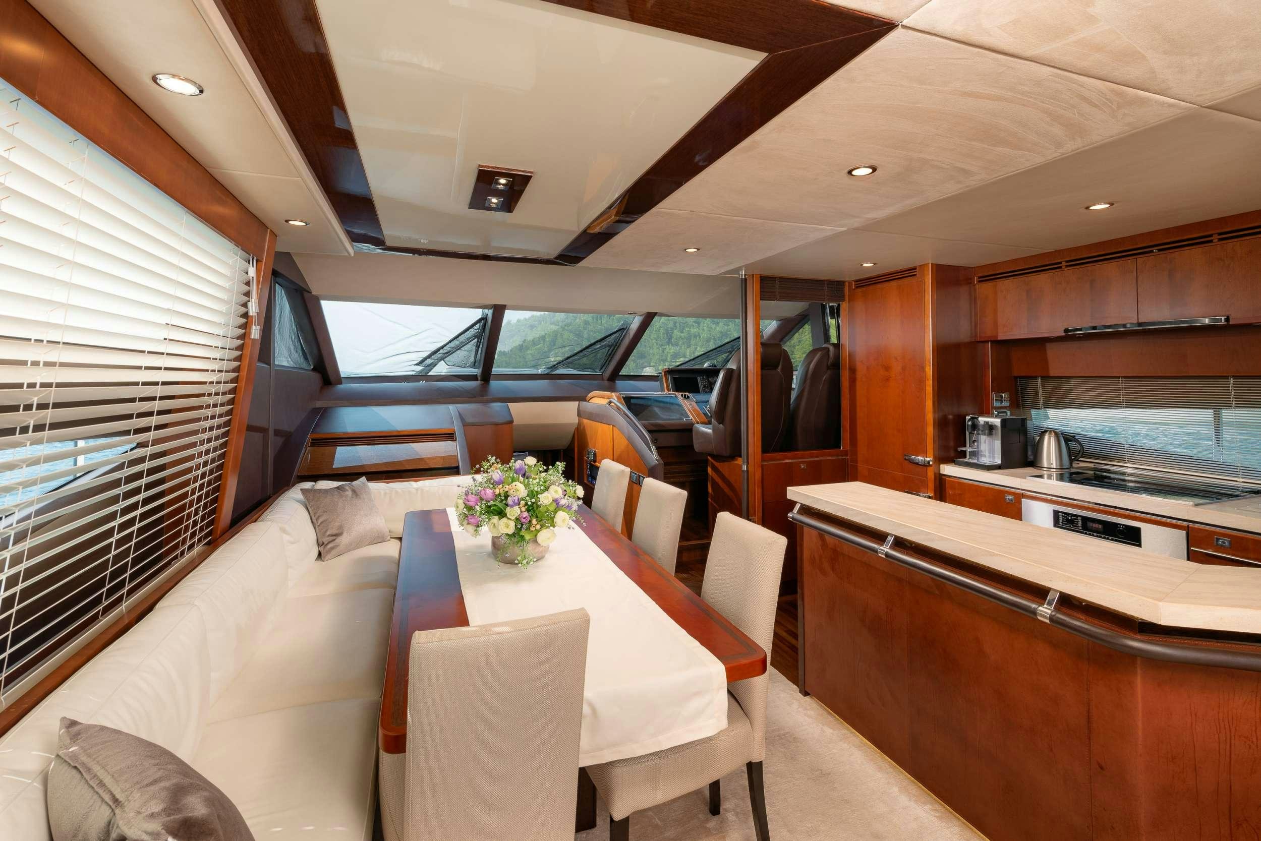 a train car with a table and chairs aboard PRINCESS 72 FLY CHAMPION Yacht for Charter