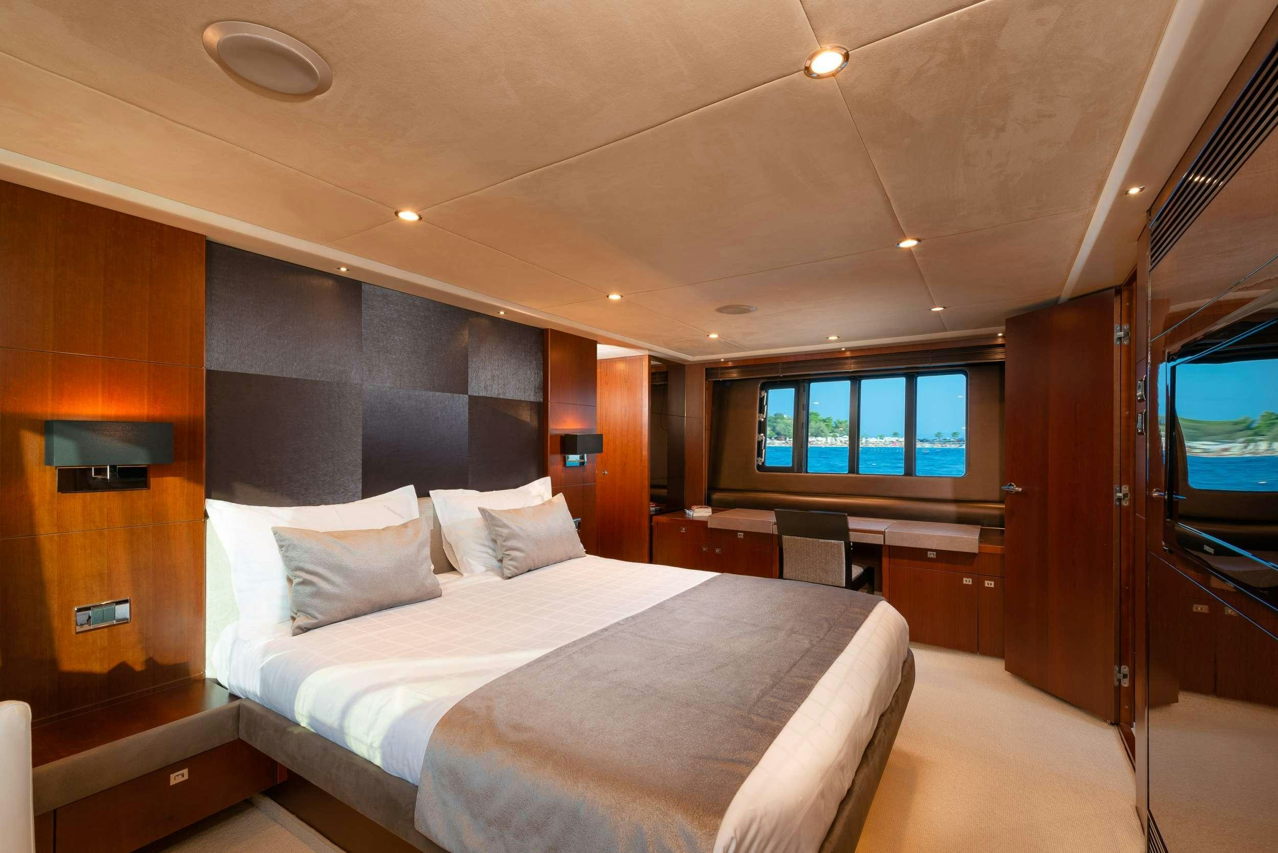 a hotel room with a bed aboard PRINCESS 72 FLY CHAMPION Yacht for Charter