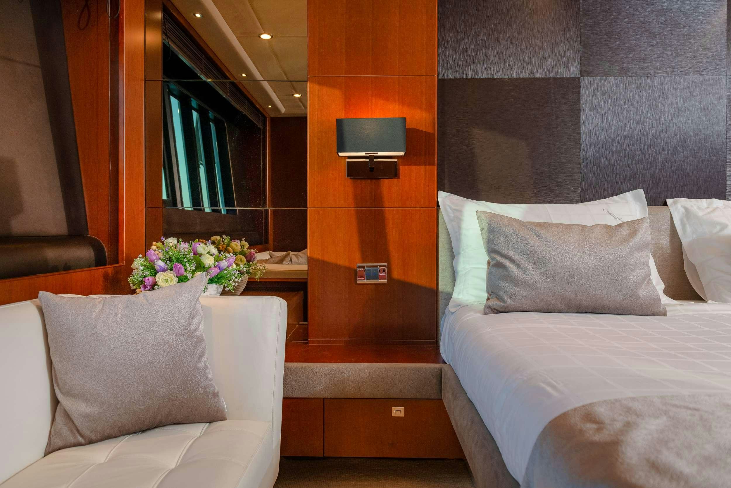 a room with a bed and a television aboard PRINCESS 72 FLY CHAMPION Yacht for Charter
