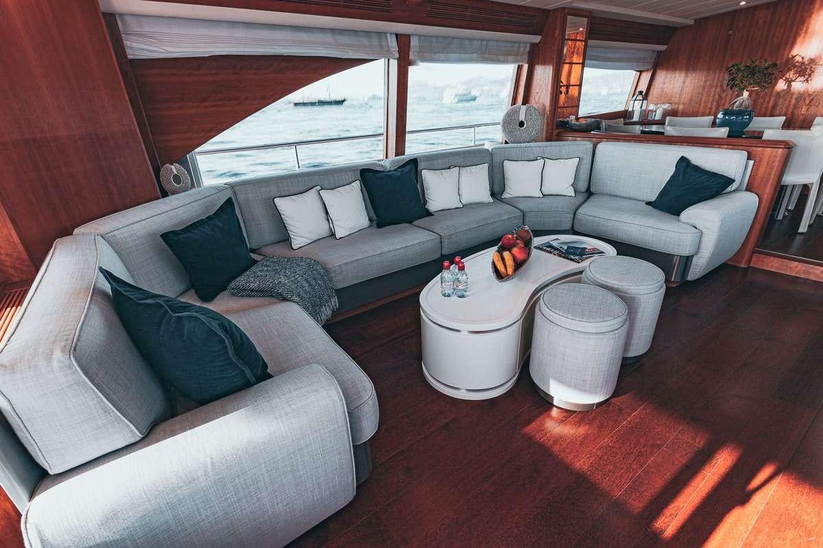 a living room with a couch and a table aboard LADY AMANDA Yacht for Charter