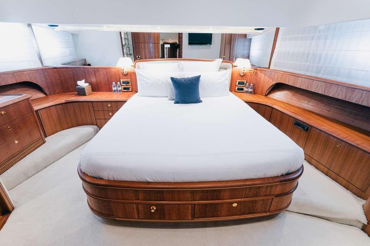 a bed with a white sheet aboard LADY AMANDA Yacht for Charter