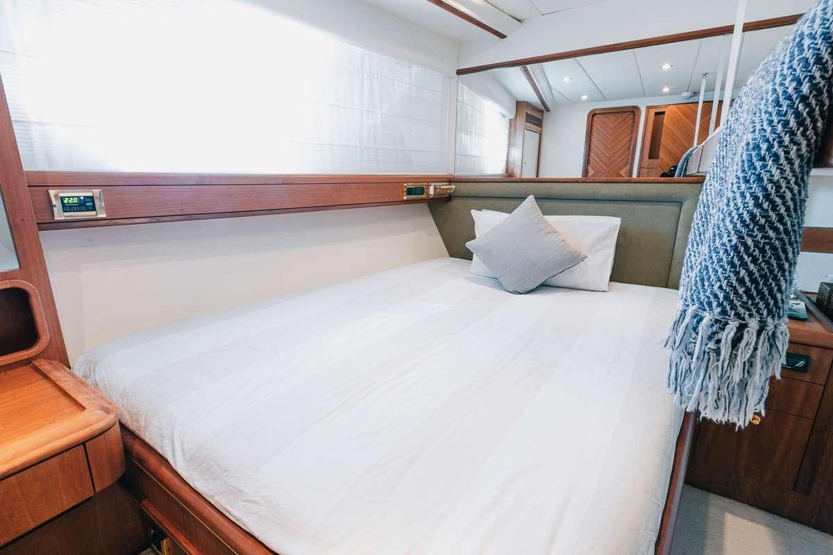 a bed with white sheets aboard LADY AMANDA Yacht for Charter