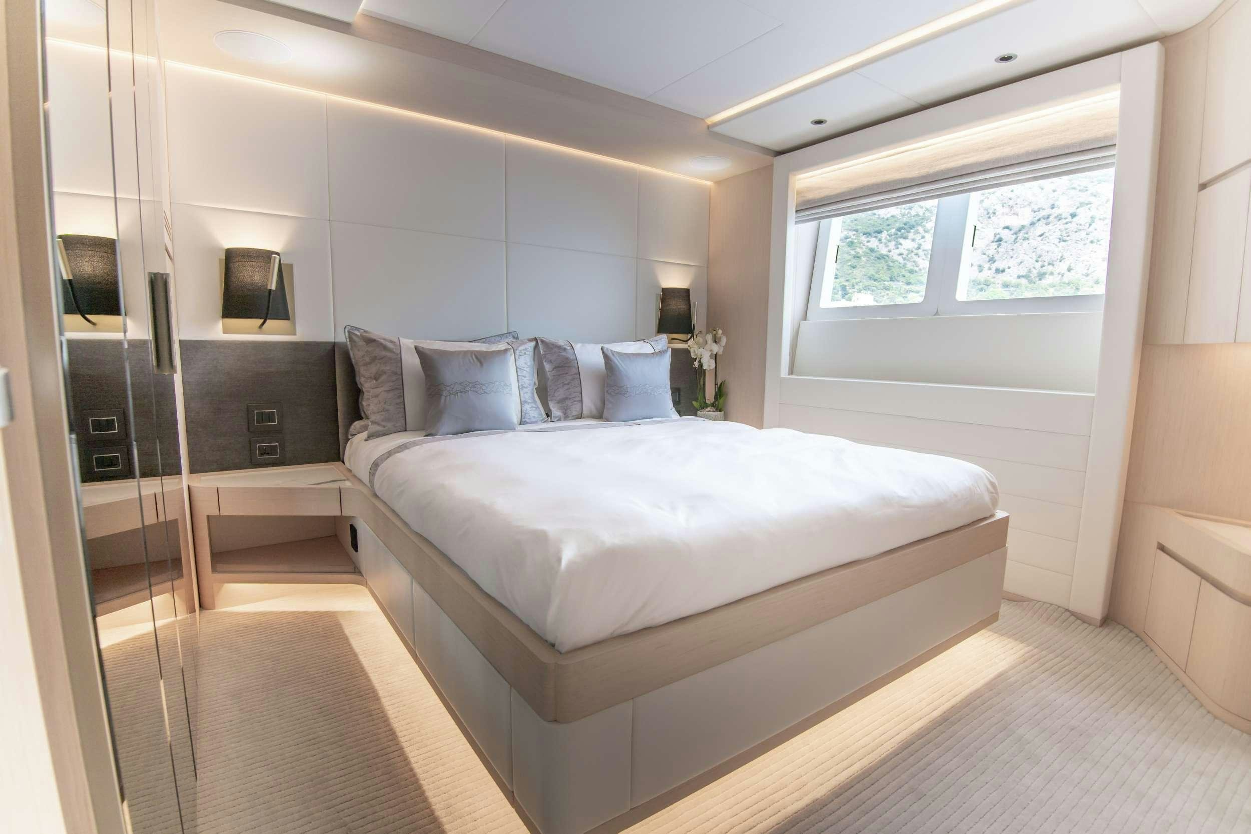 a bedroom with a bed and a window aboard OCEAN VIEW Yacht for Charter