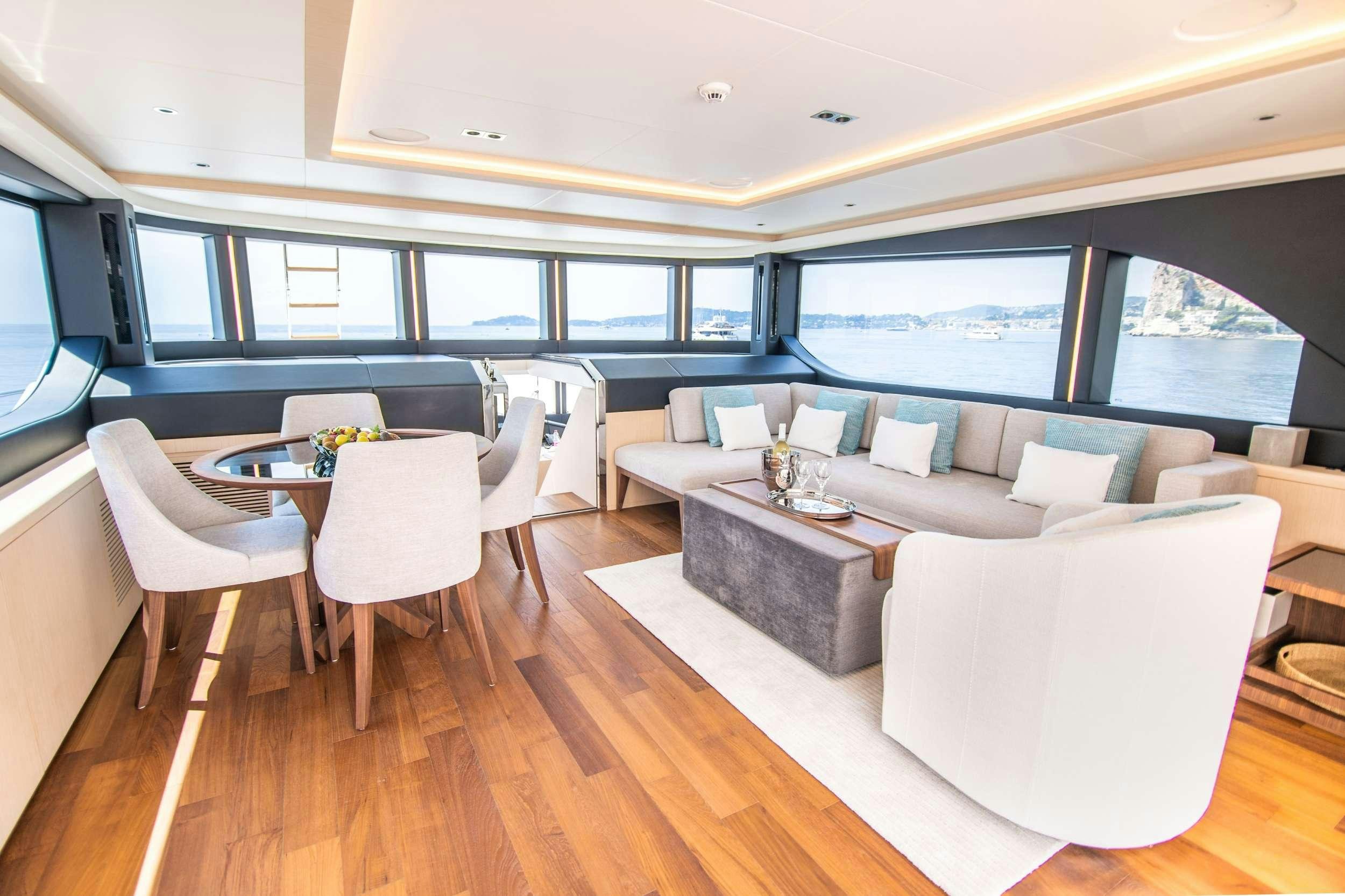 a room with a table and chairs aboard OCEAN VIEW Yacht for Charter