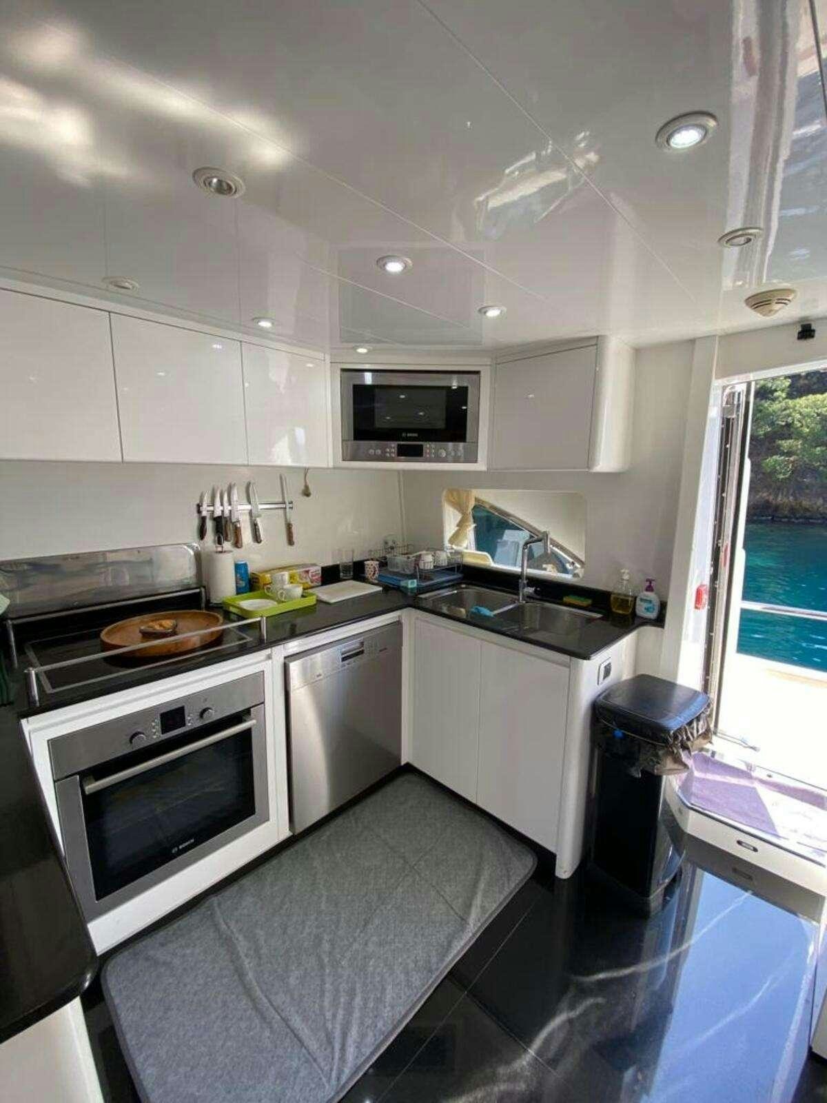 a kitchen with white cabinets aboard BORAM Yacht for Charter