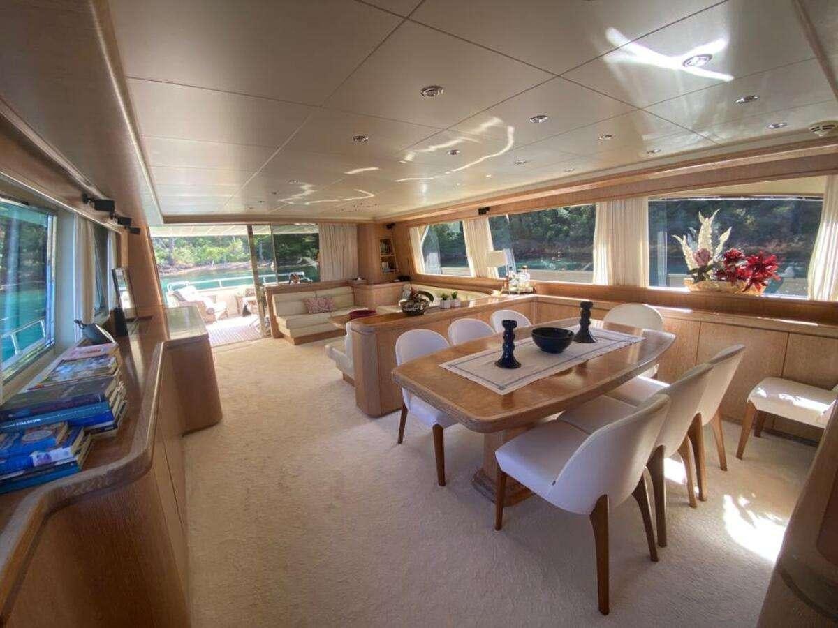 a room with a table and chairs aboard BORAM Yacht for Charter
