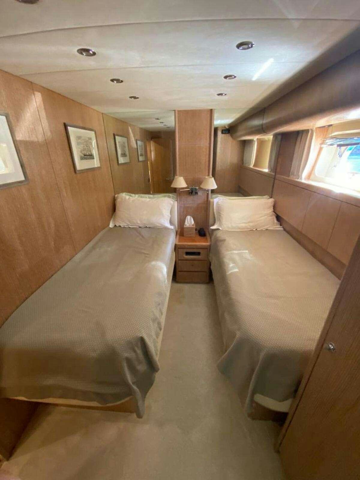 a room with a bed and a desk aboard BORAM Yacht for Charter
