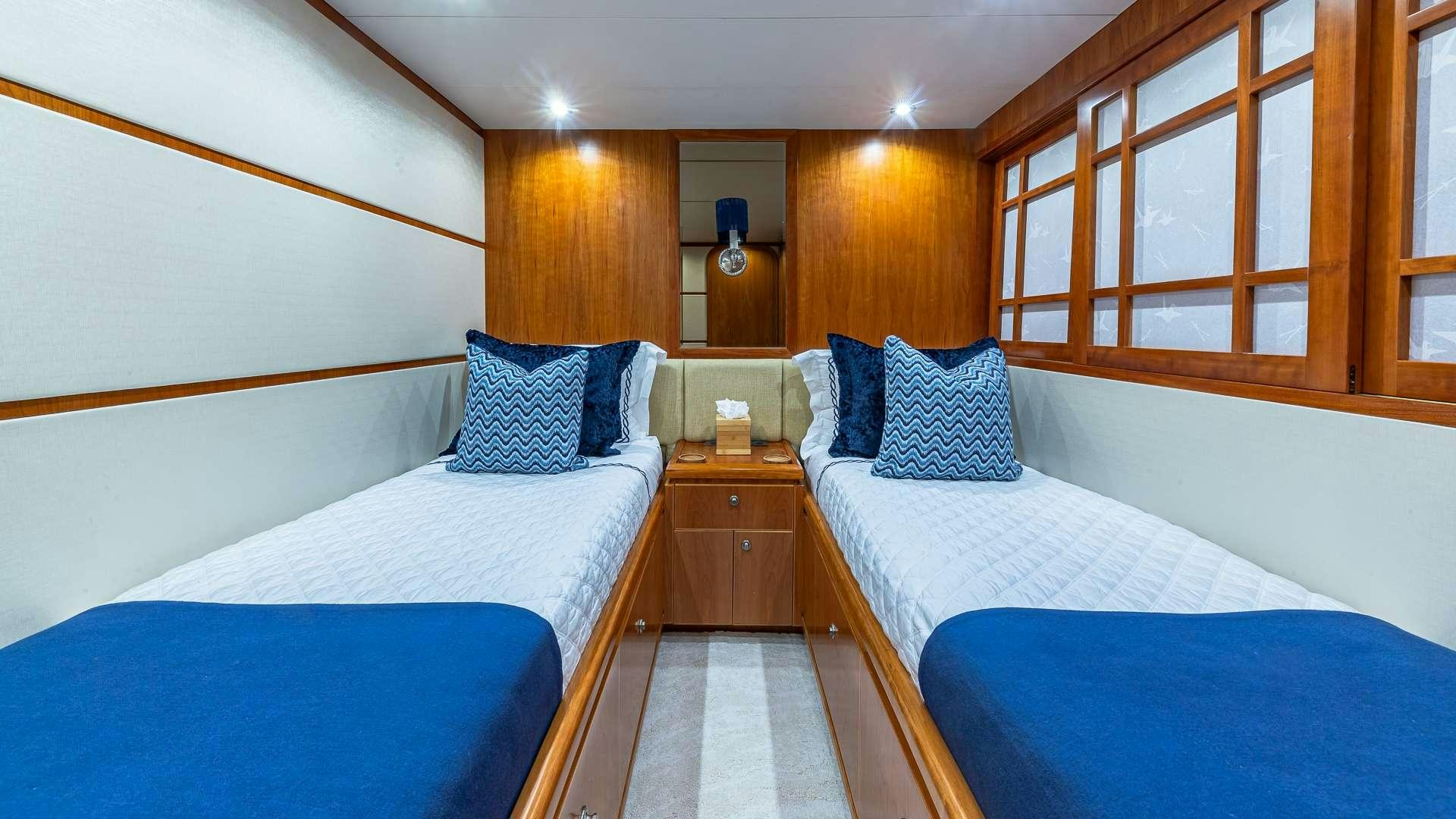 a room with beds and a window aboard B HAPPY Yacht for Charter