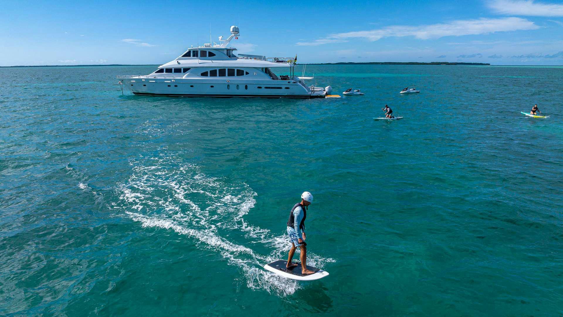 a person surfing in the sea aboard B HAPPY Yacht for Charter