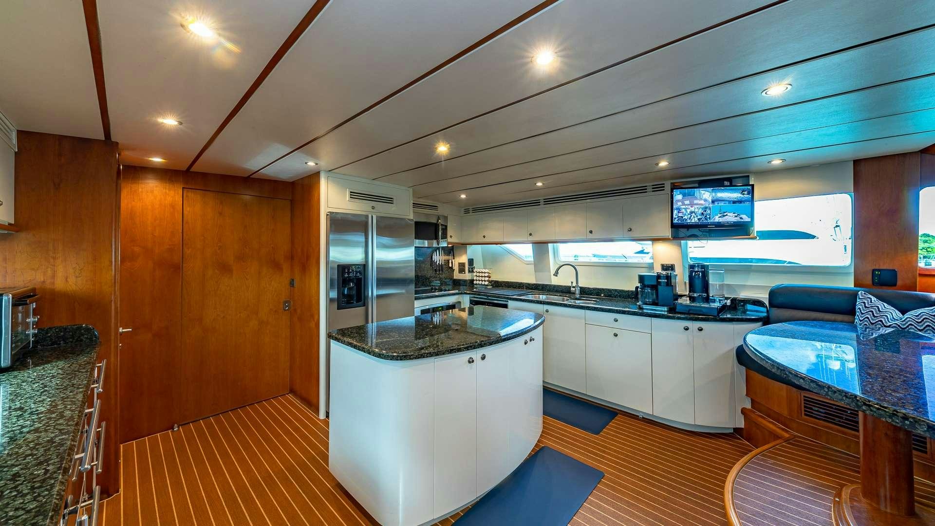 a large kitchen with a large island aboard B HAPPY Yacht for Charter