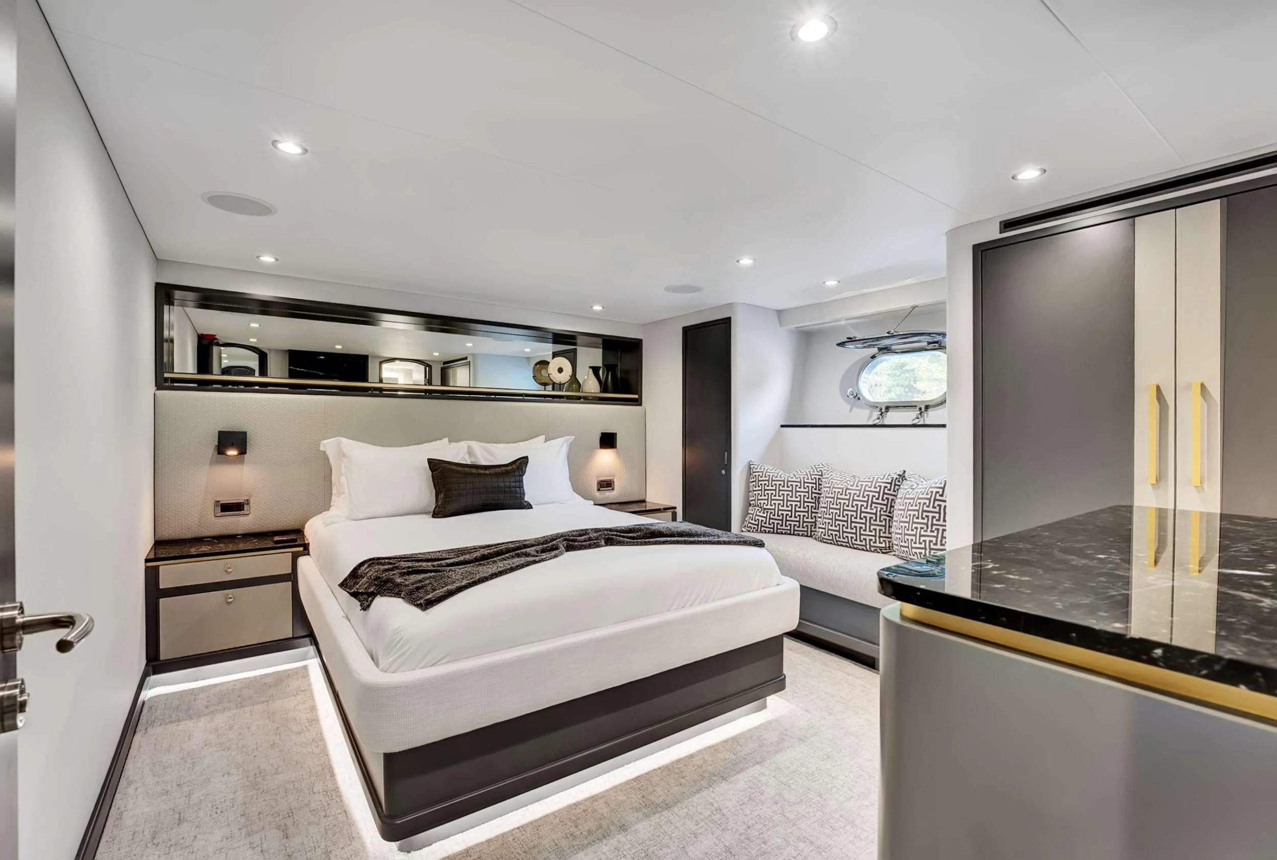 a bedroom with a bed and a couch aboard MAS GRANDE Yacht for Charter