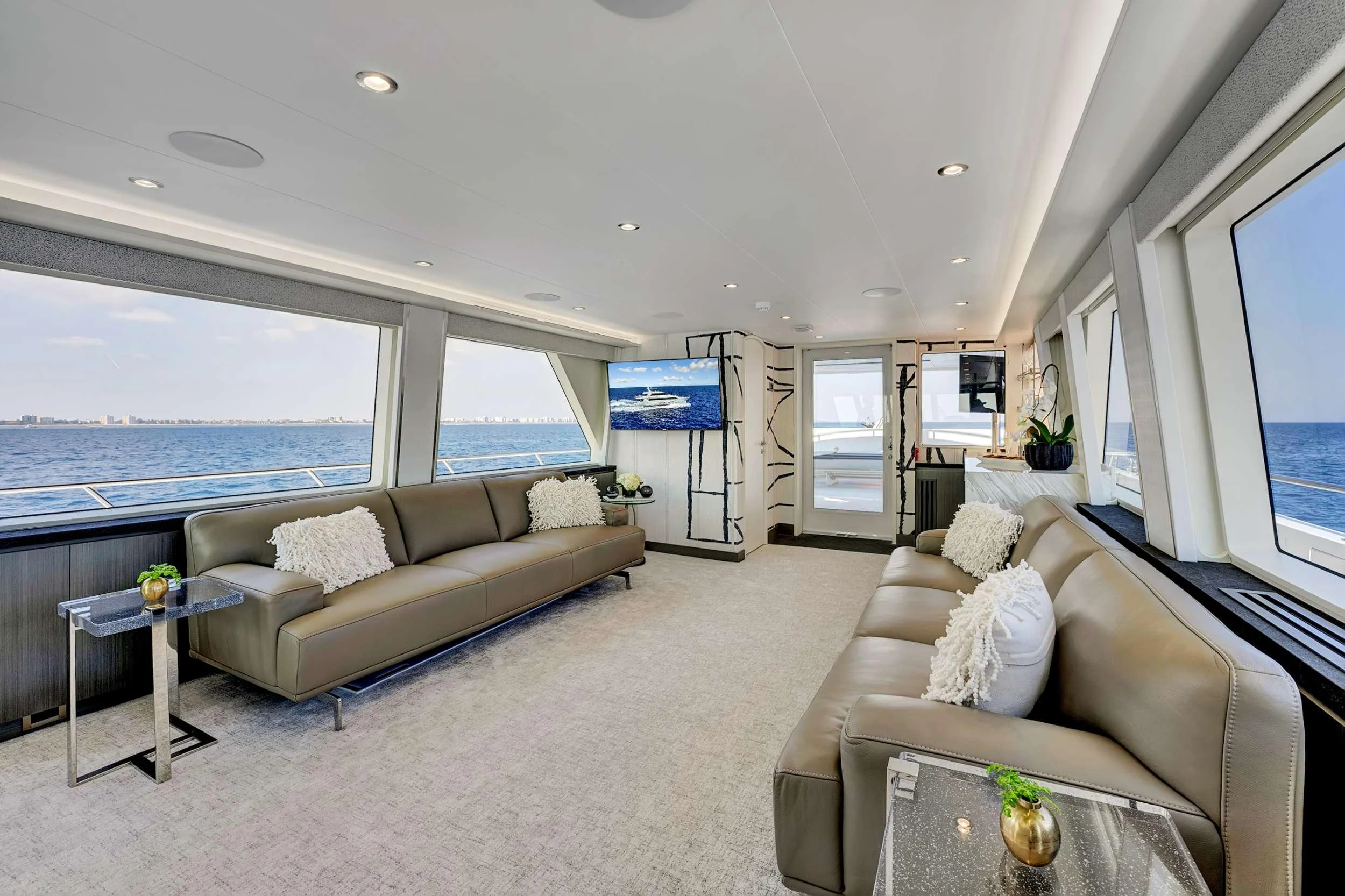 a living room with a large window aboard MAS GRANDE Yacht for Charter