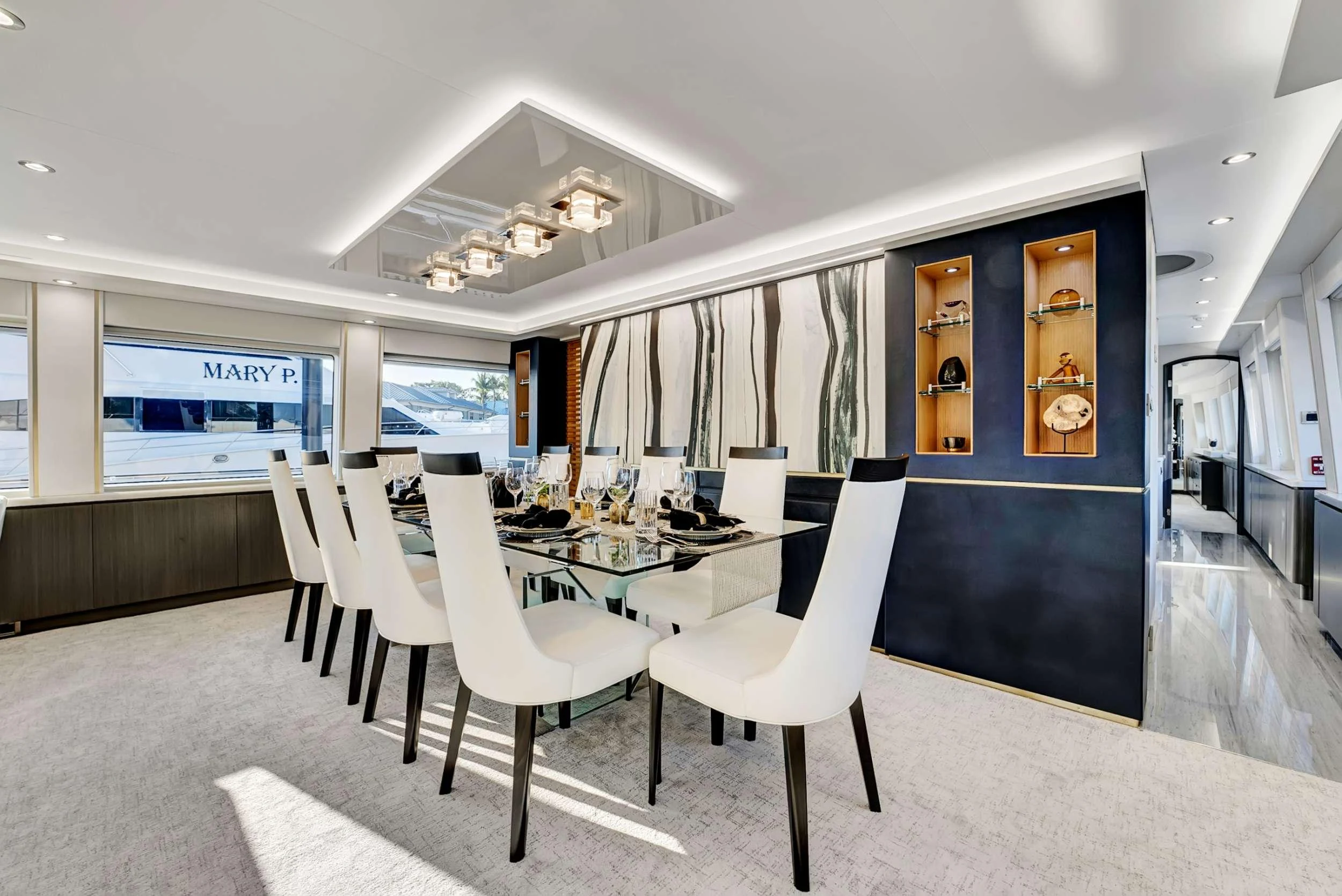 a room with a table chairs and a window aboard MAS GRANDE Yacht for Charter