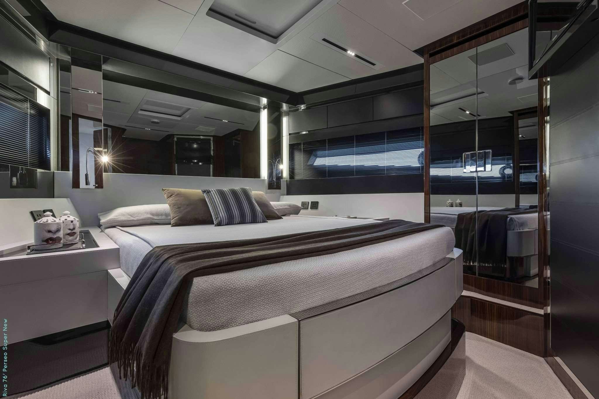 a room with a bed and a desk aboard RECREATIONAL USE Yacht for Charter