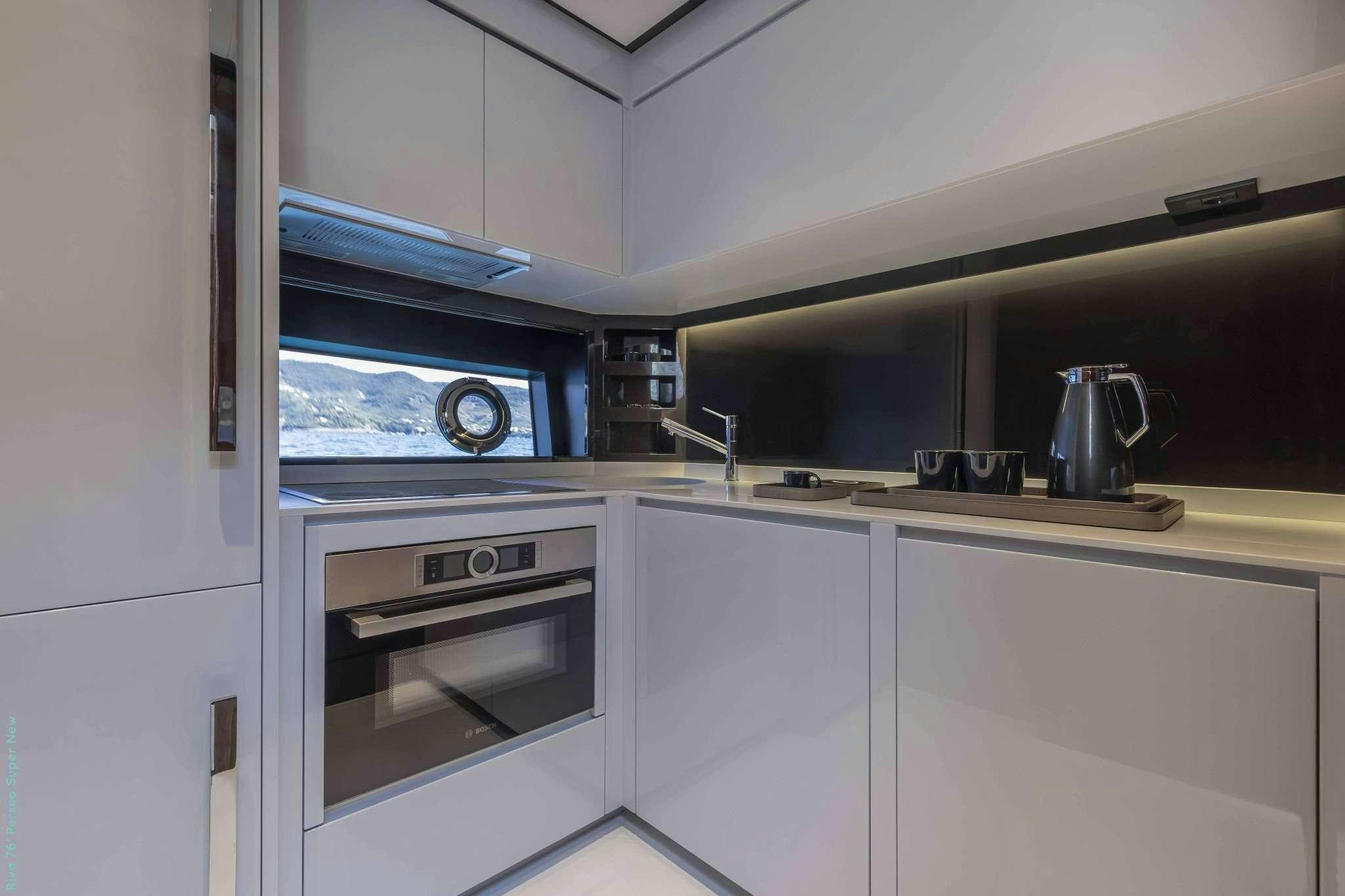 a kitchen with white cabinets aboard RECREATIONAL USE Yacht for Charter