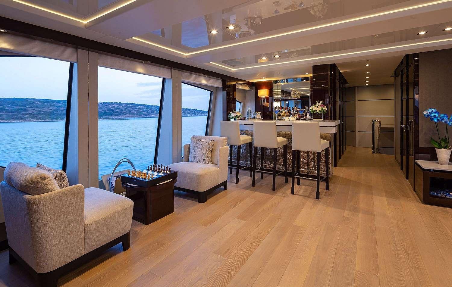 a living room with a large window aboard AQUA LIBRA Yacht for Charter