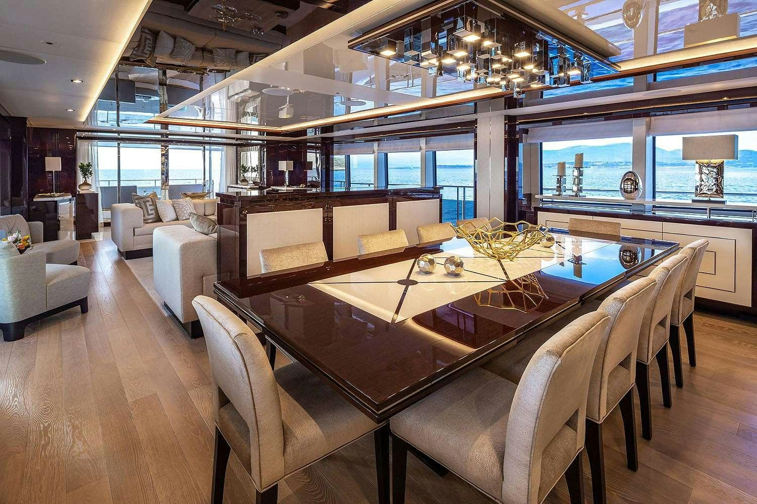 a living room with a large table aboard AQUA LIBRA Yacht for Charter