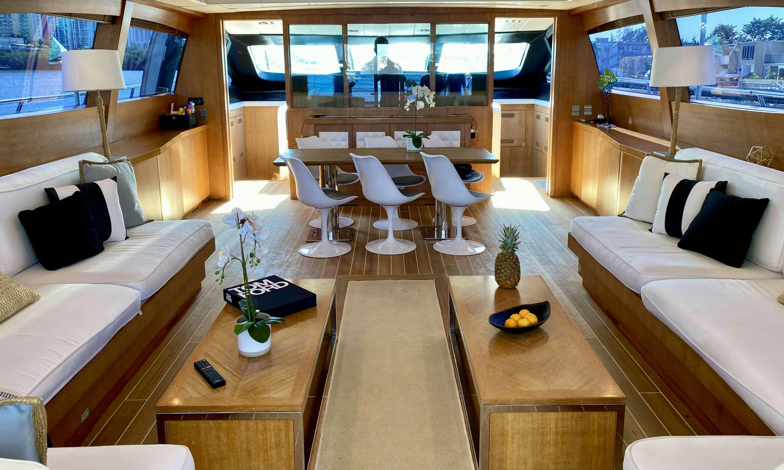 a room with a couch and a table and chairs aboard SMILE Yacht for Charter