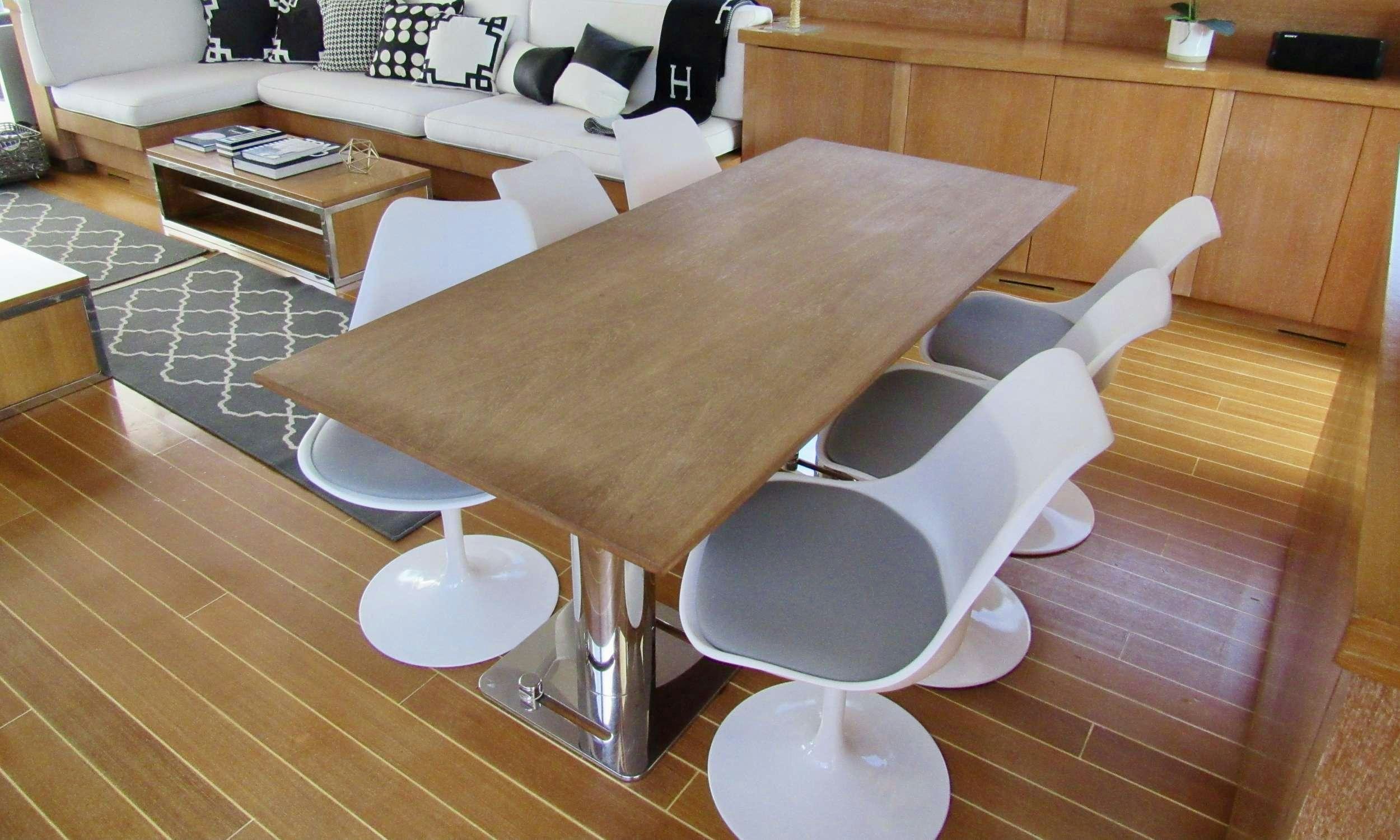 a table with chairs around it aboard SMILE Yacht for Charter
