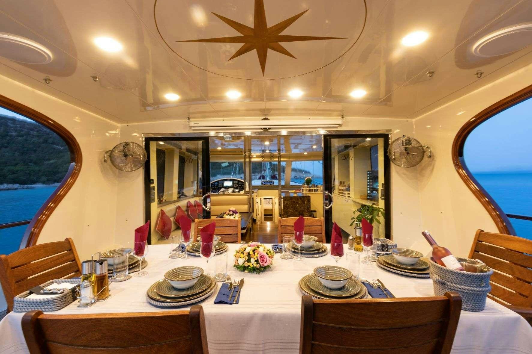 a dining room with a large table aboard SIYU Yacht for Charter