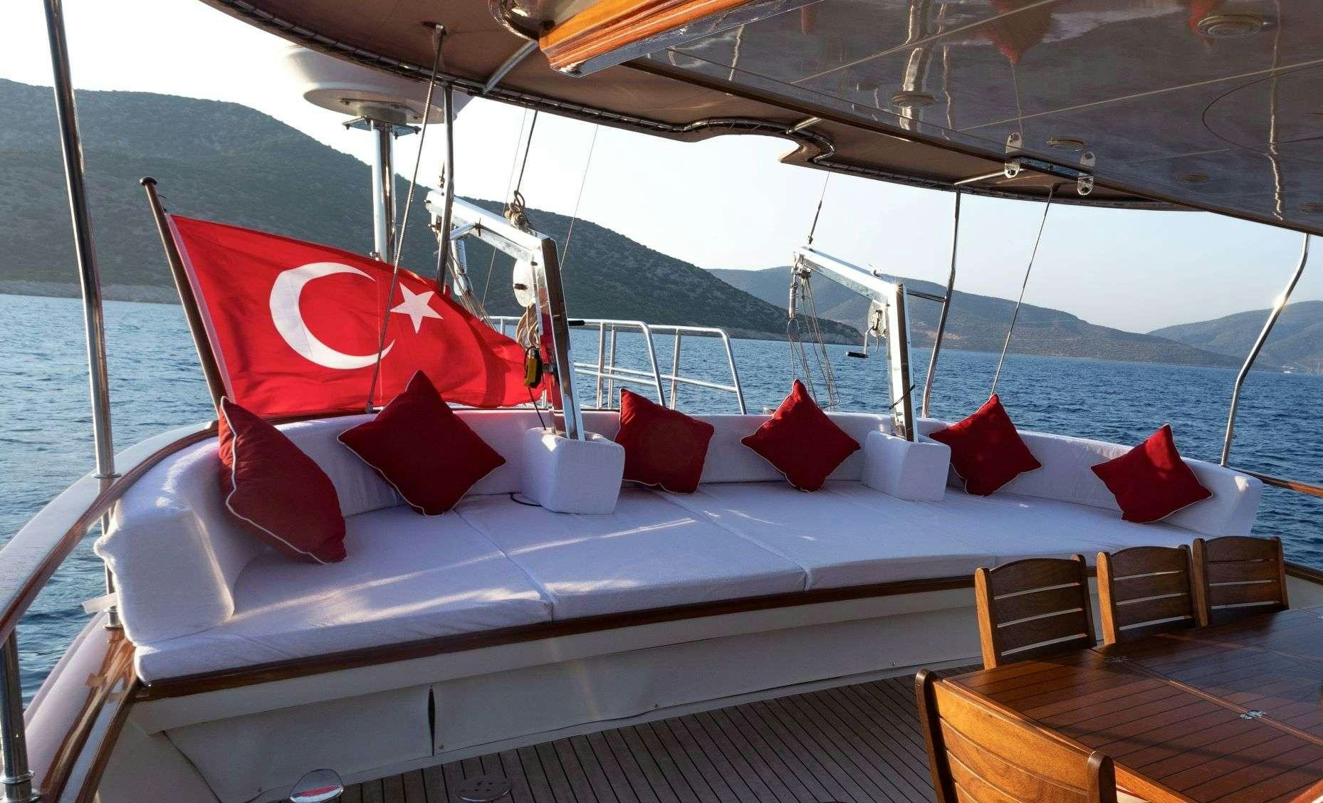 a large bed with pillows on it aboard SIYU Yacht for Charter