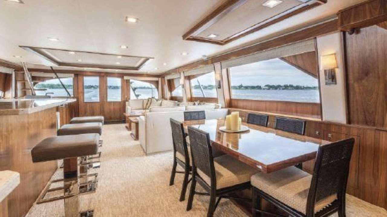 a large room with a table and chairs aboard TOUCHE Yacht for Charter