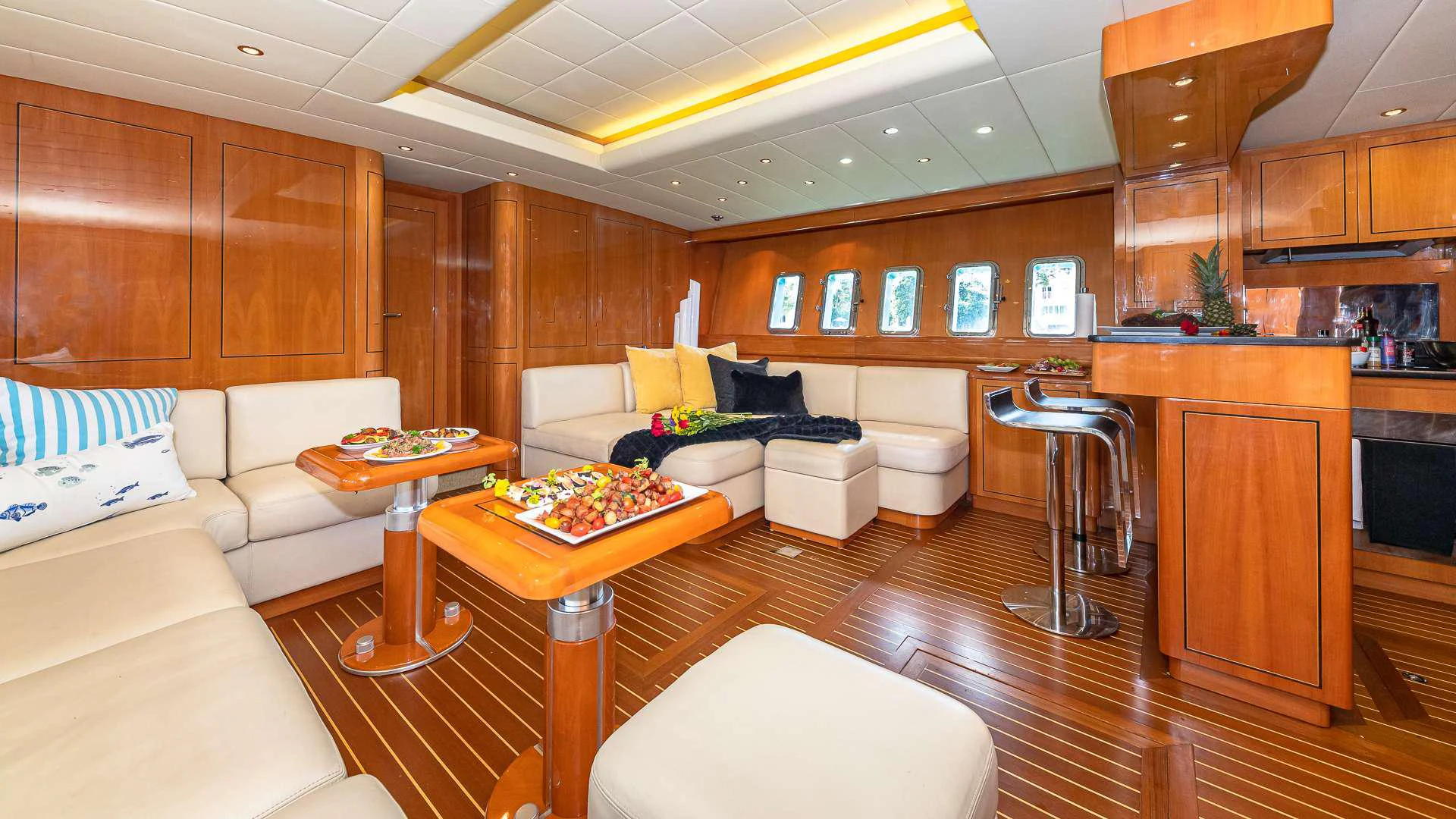 a living room with wood cabinets aboard HAPPY Yacht for Charter