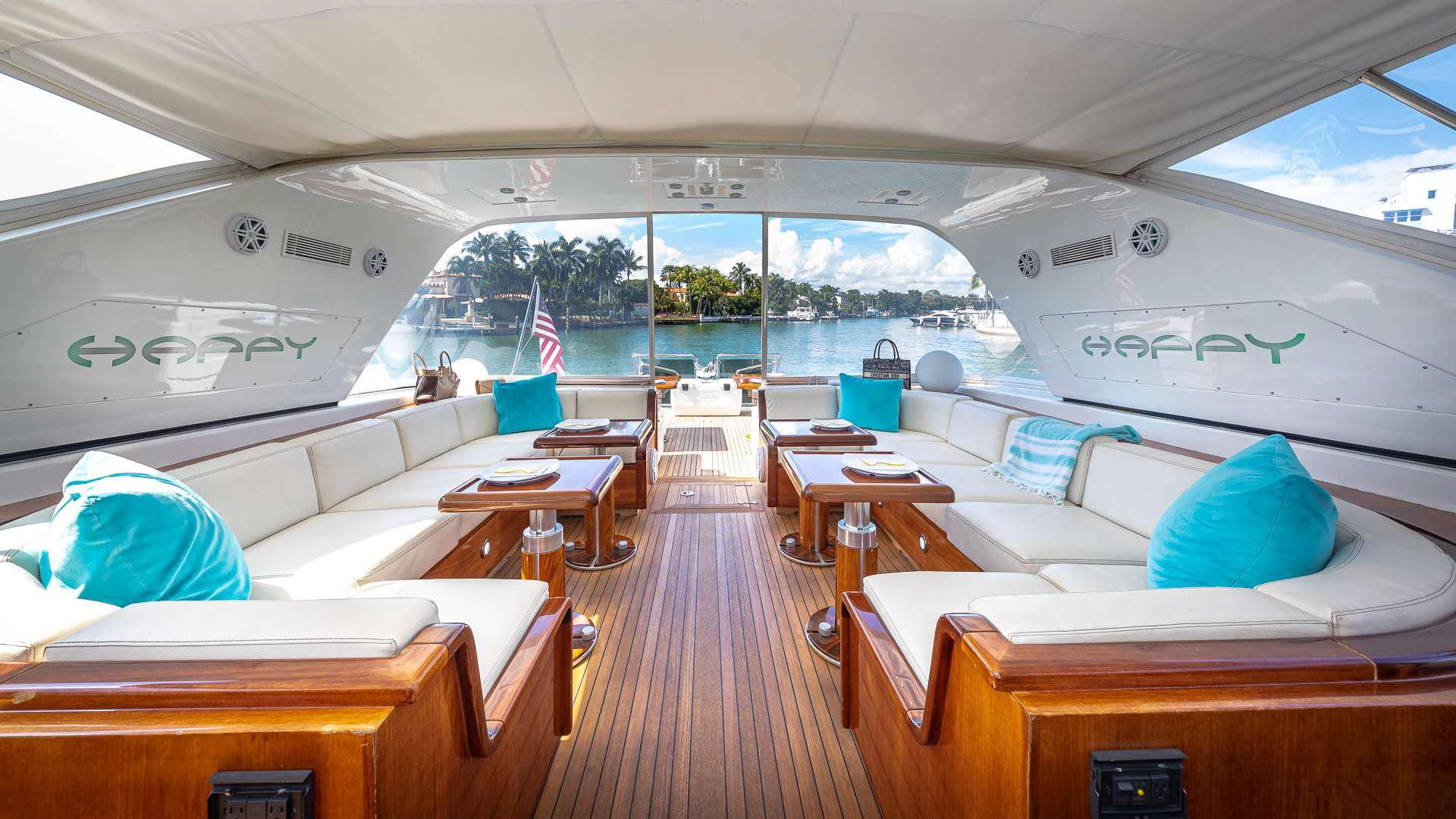 a boat with a large deck aboard HAPPY Yacht for Charter