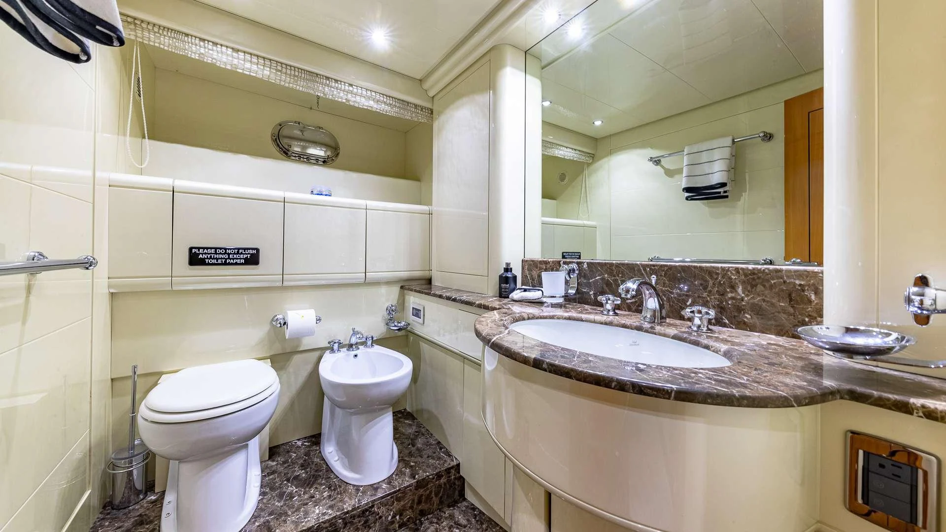 a bathroom with a large mirror aboard HAPPY Yacht for Charter
