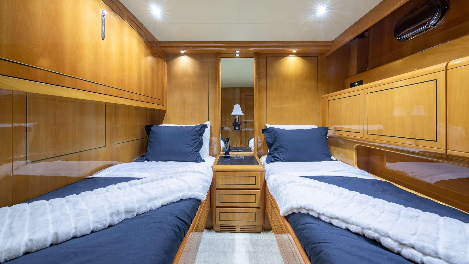 a room with a bed and a dresser aboard HAPPY Yacht for Charter