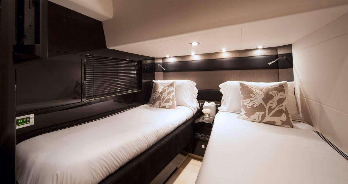 a room with two beds aboard ALL IN Yacht for Charter