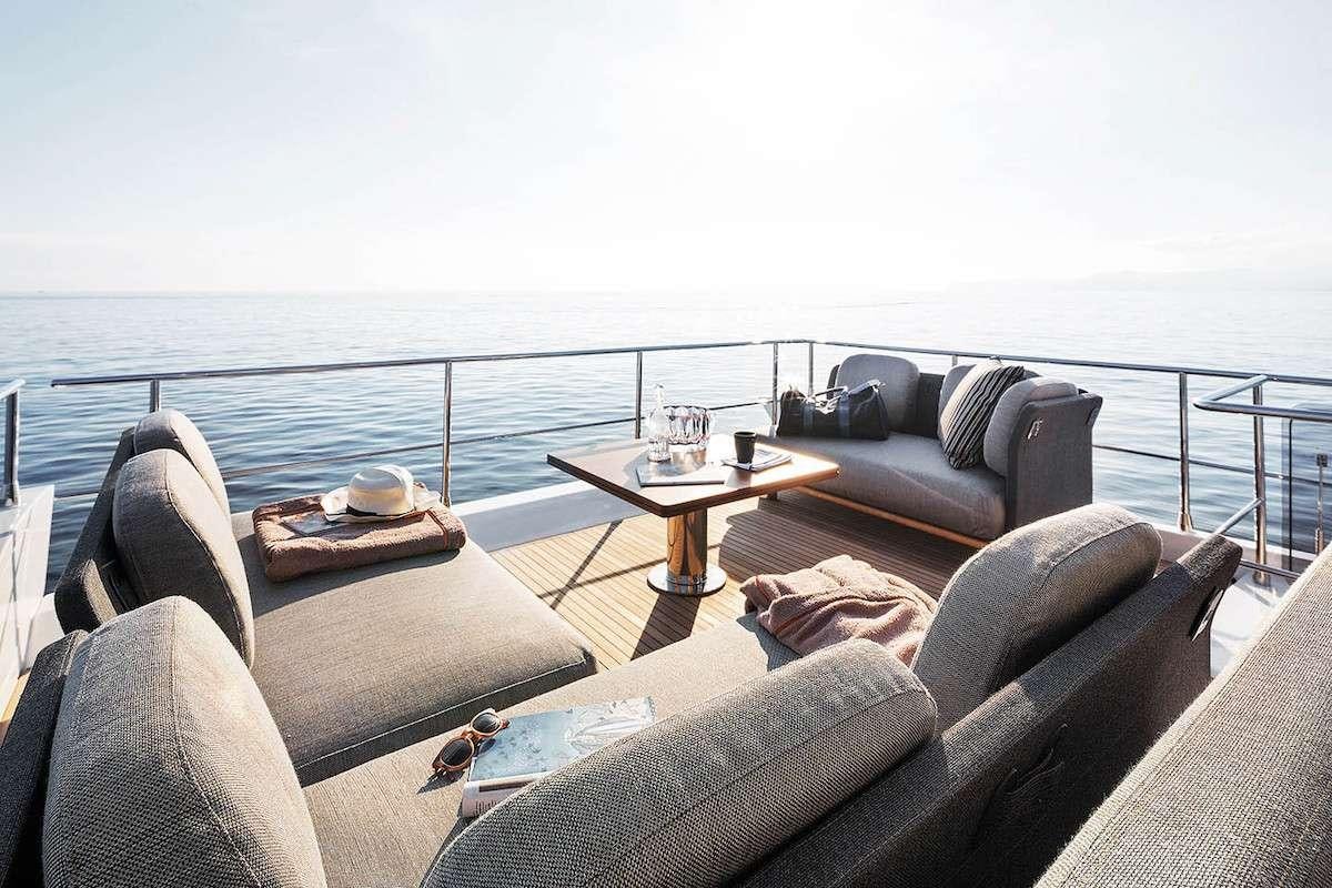a table and chairs on a balcony aboard CERULEAN Yacht for Charter