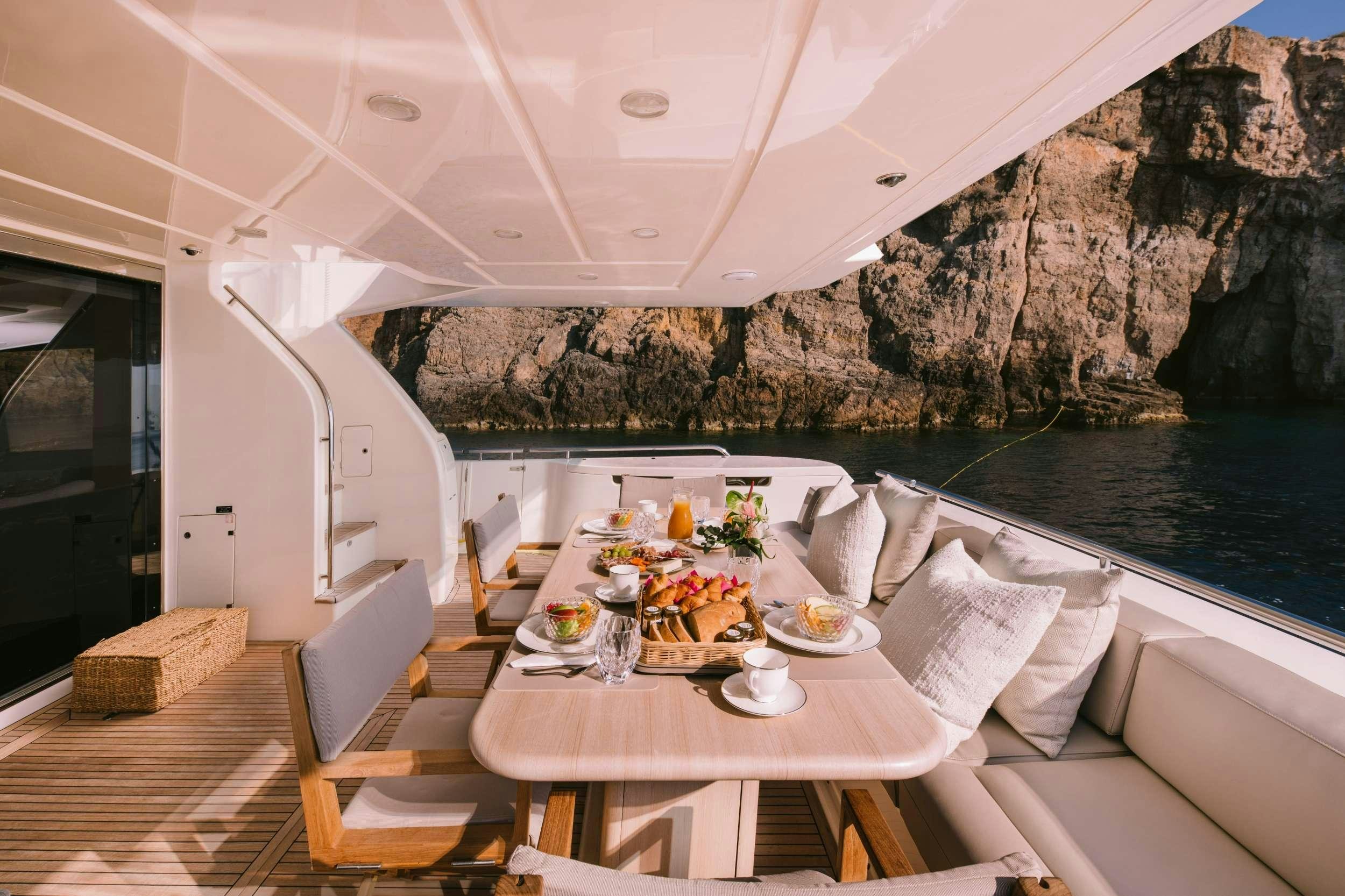a table set for a meal on a boat aboard D&AMP;D Yacht for Charter