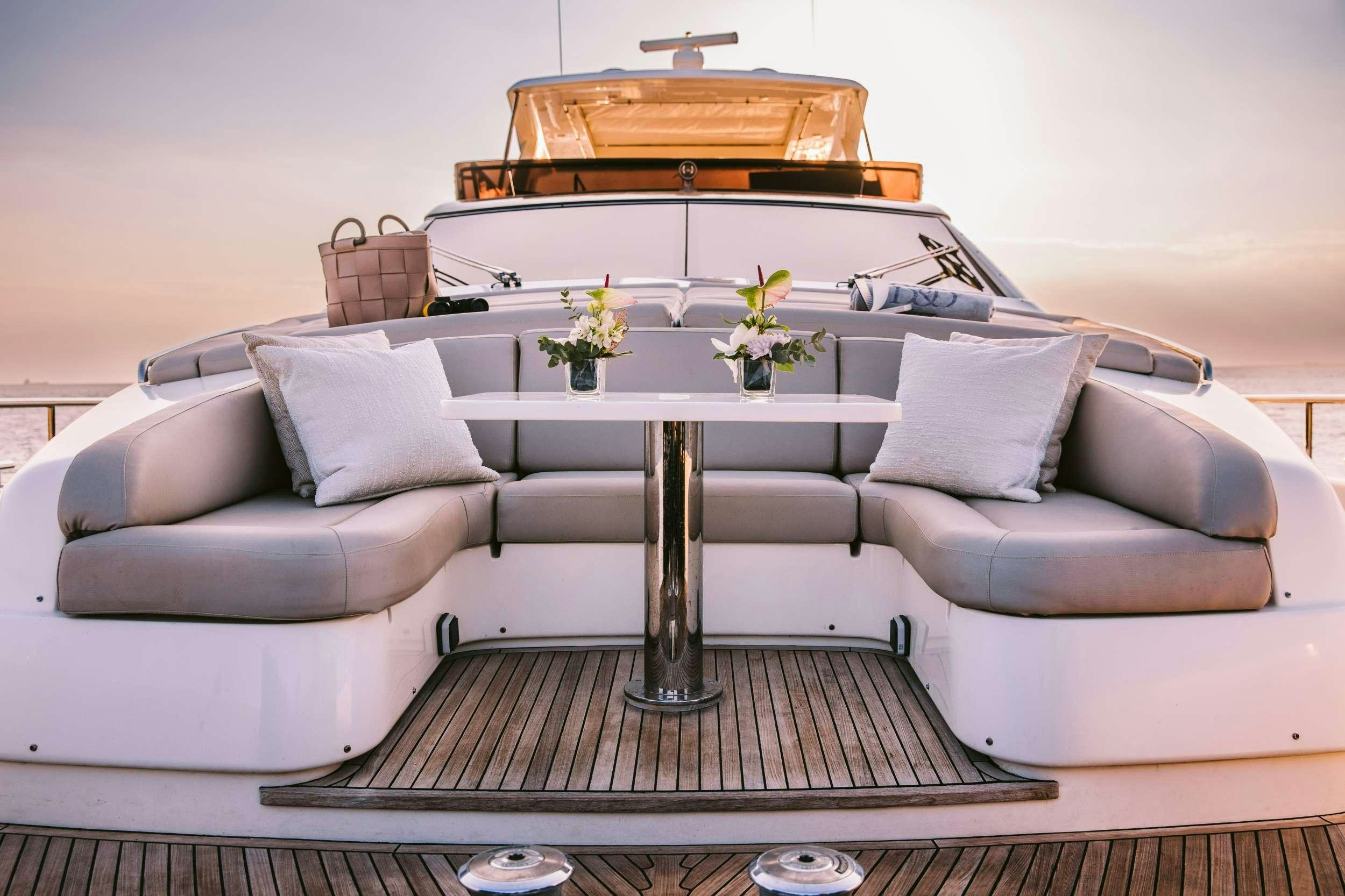 a white couch with a piano on top of it aboard D&AMP;D Yacht for Charter
