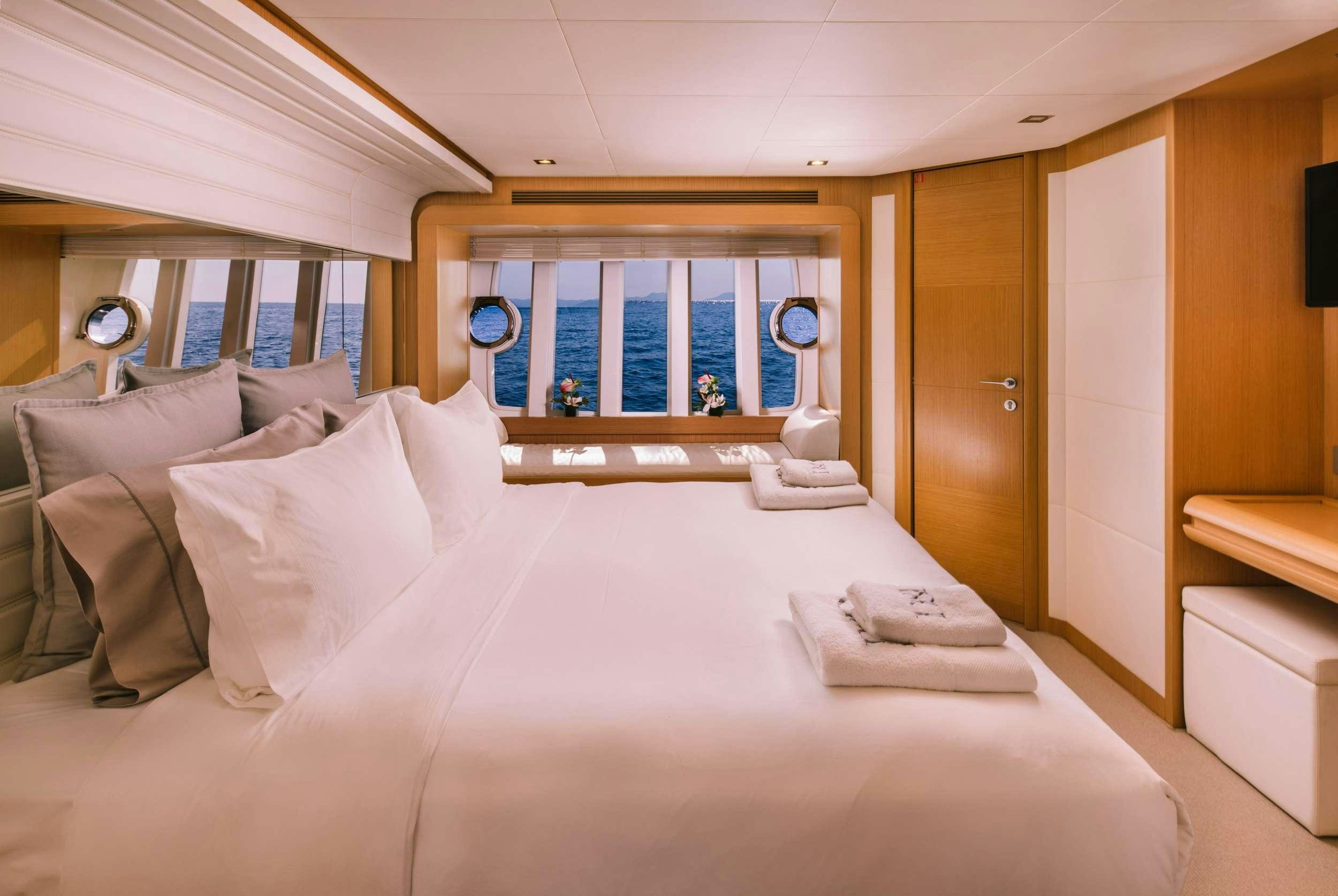 a bed with white sheets aboard D&AMP;D Yacht for Charter