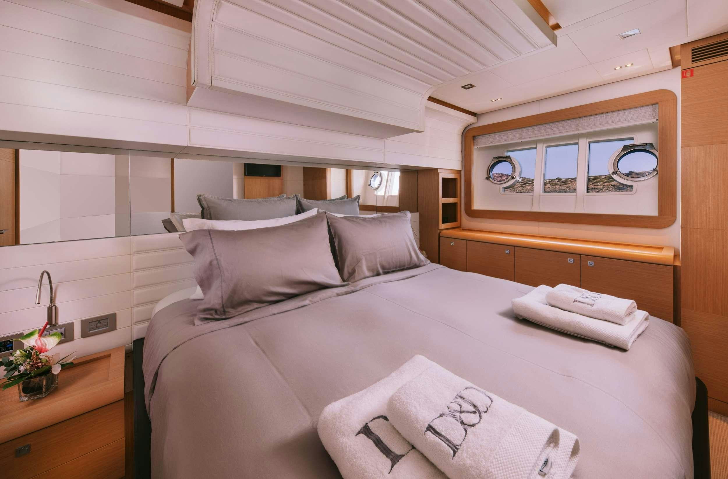 a bed with a white comforter and pillows aboard D&AMP;D Yacht for Charter
