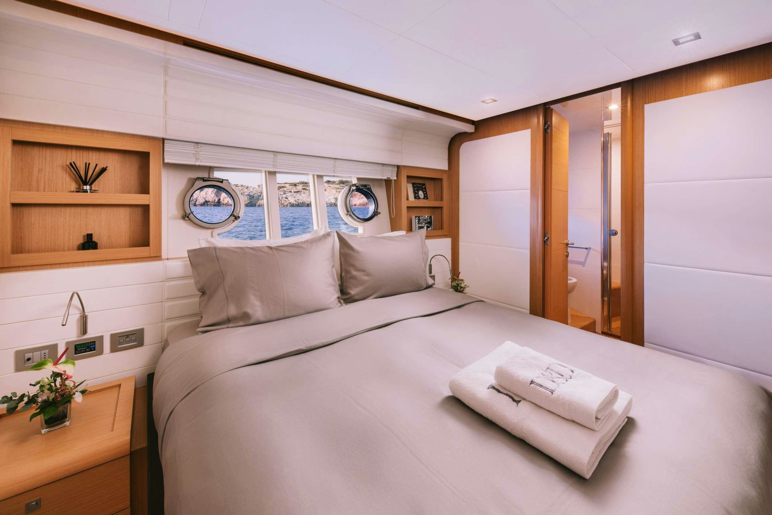 a bed with white sheets and pillows aboard D&AMP;D Yacht for Charter