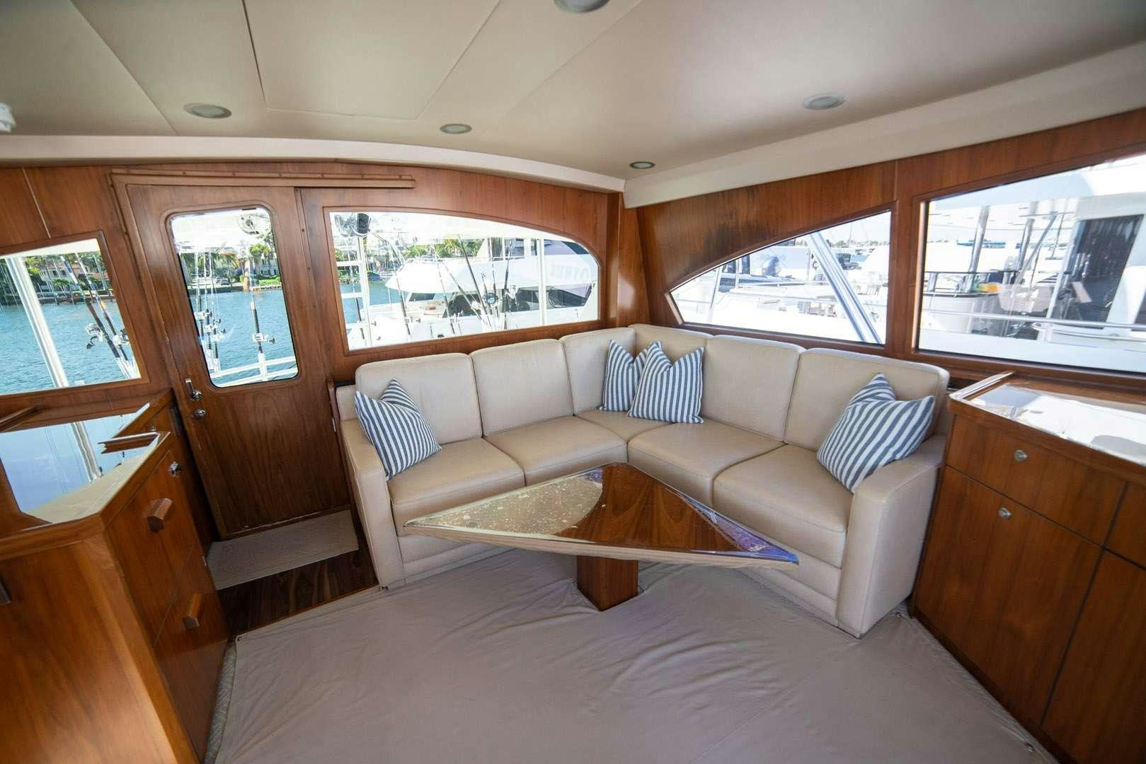 a living room with a couch and a table aboard FA-LA-ME Yacht for Charter